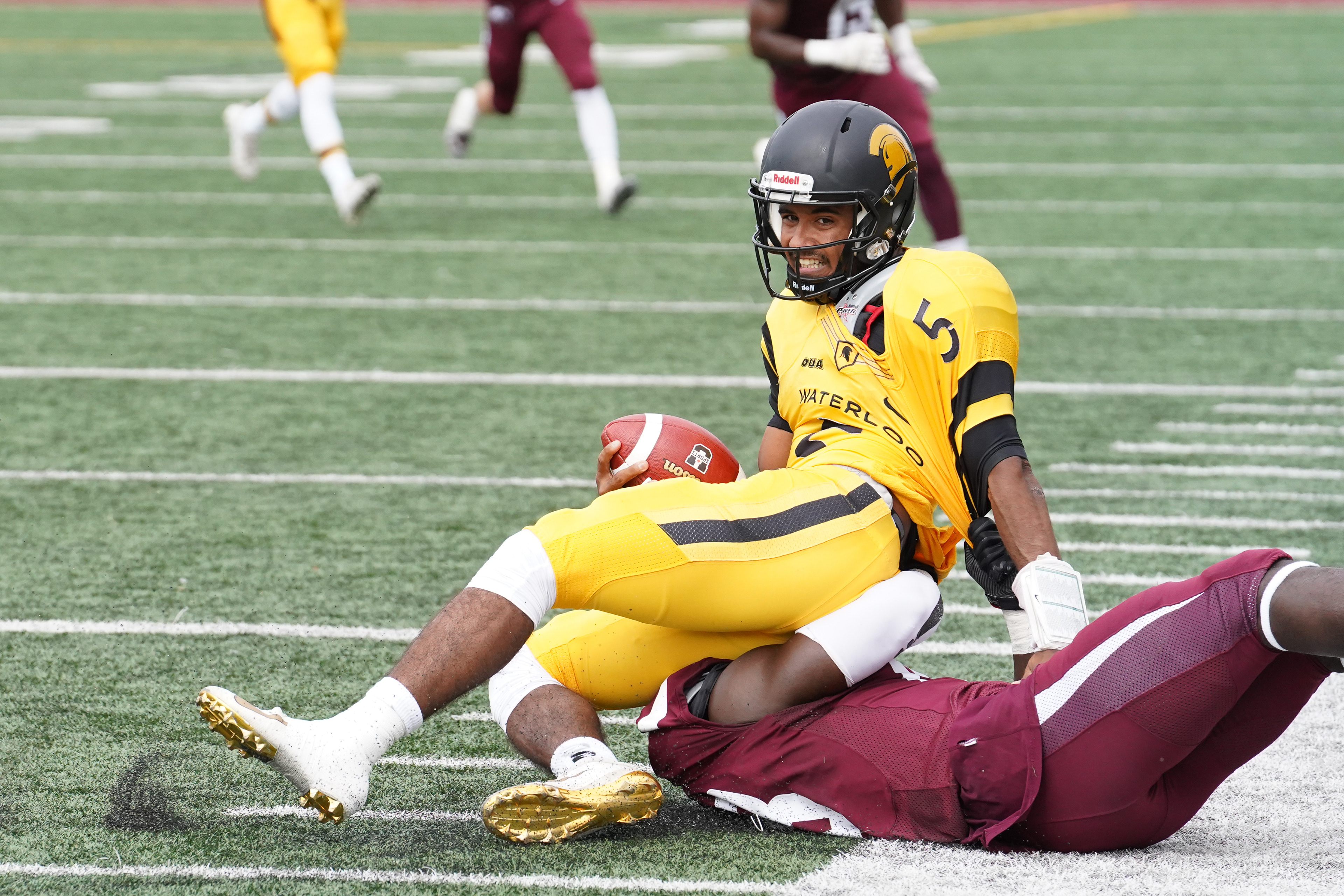 Waterloo quarterback Tre Ford is sacked by McMaster's Enoch Penney-Laryea during the second quarter of McMaster's 34-14 win at Ron Joyce Stadium. October 2, 2021 (Photo by Jay Barlett). . 