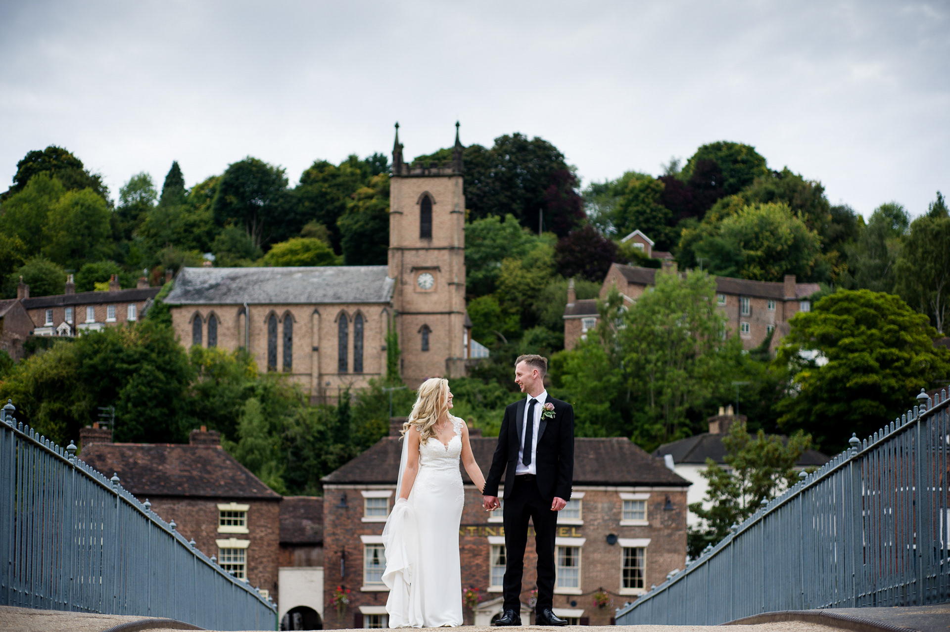 Newly wed couple is standing on the bridge in Ironbridge