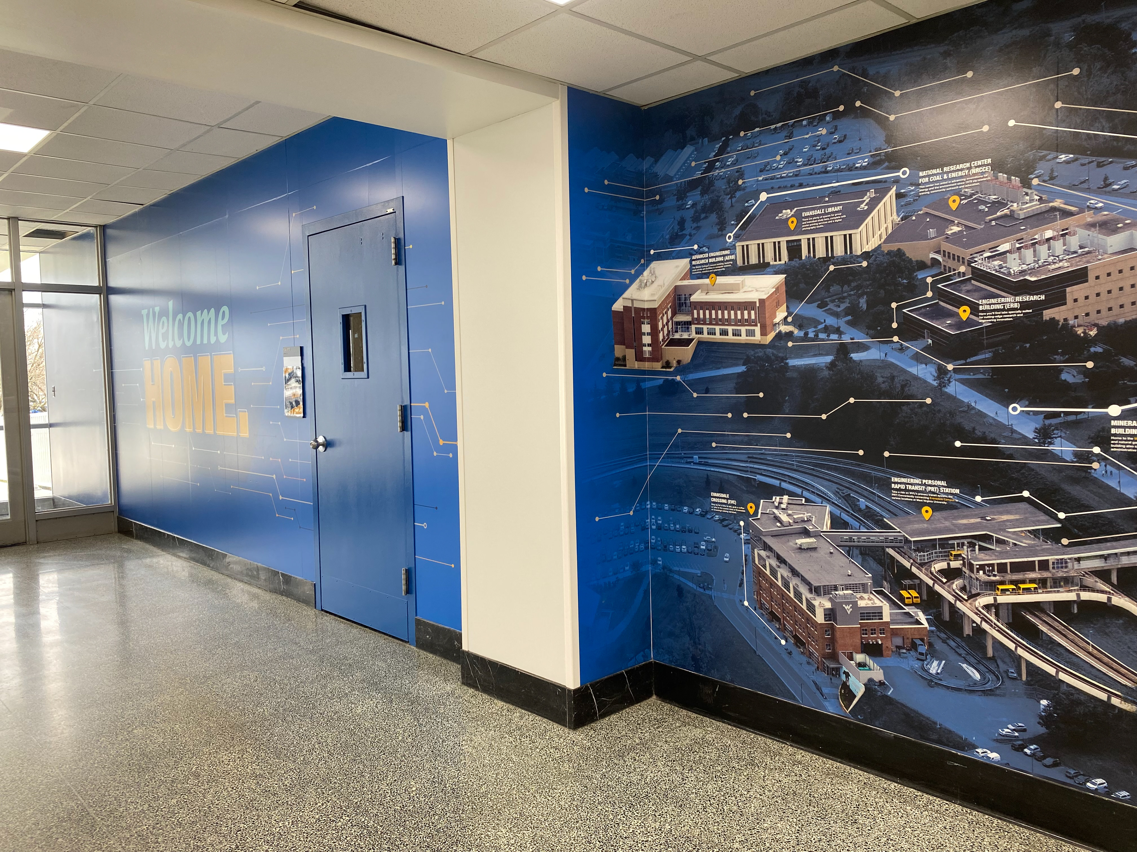 Photo of the second section of the installed wall, where the graphic turns into the aerial of campus.