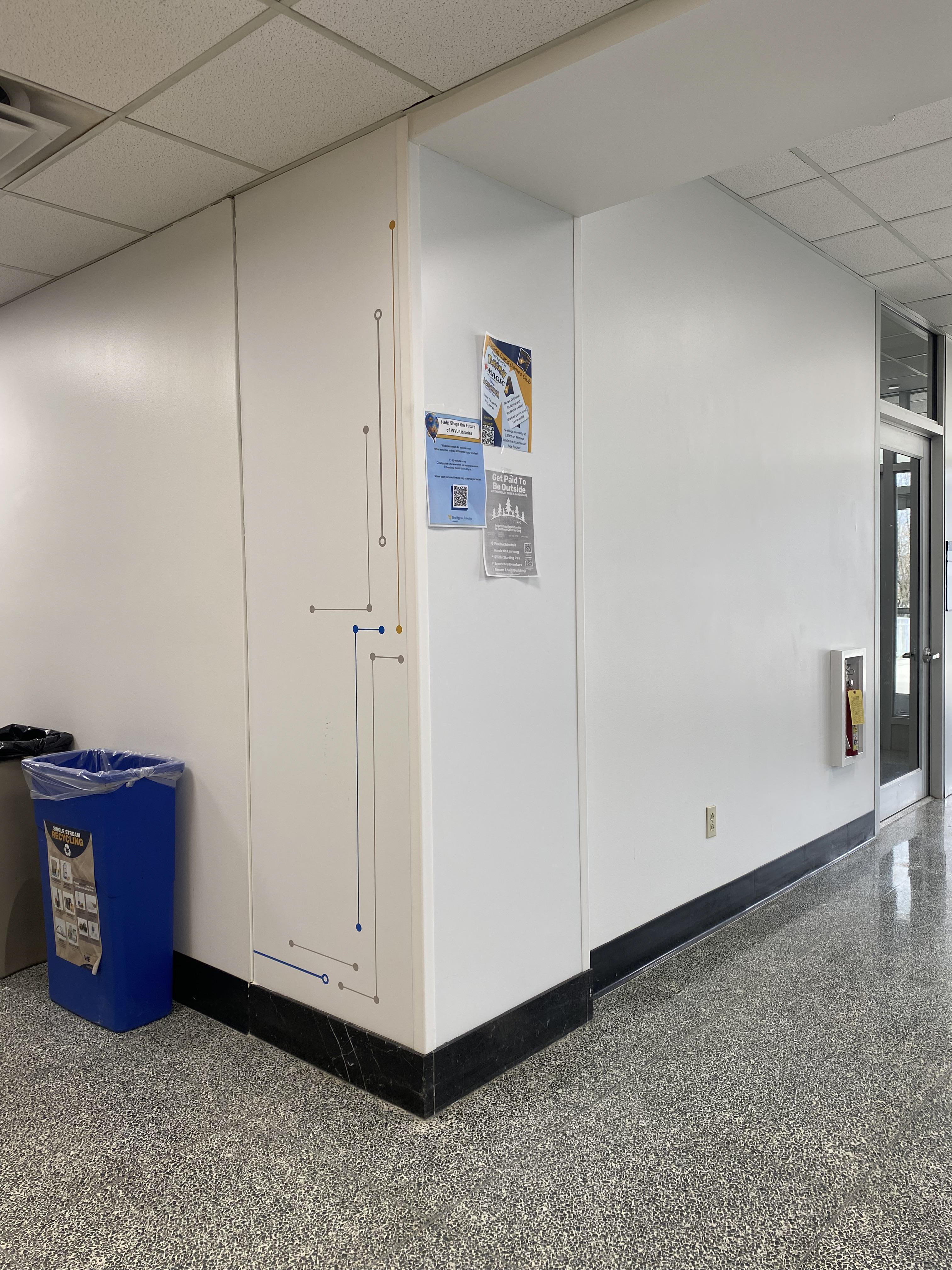 The random section of marble wall is covered by a white graphic with a few circuits that look similar to the ones on the other walls.
