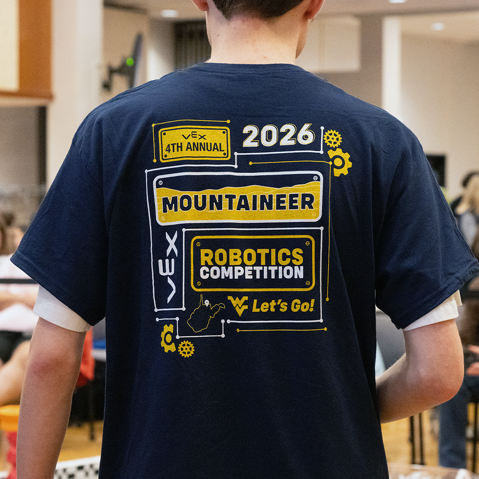2026 4th Annual VEX Mountaineer Robotics Competition t-shirt, with license plates, gears, circuits and gears framing the words on the shirt.