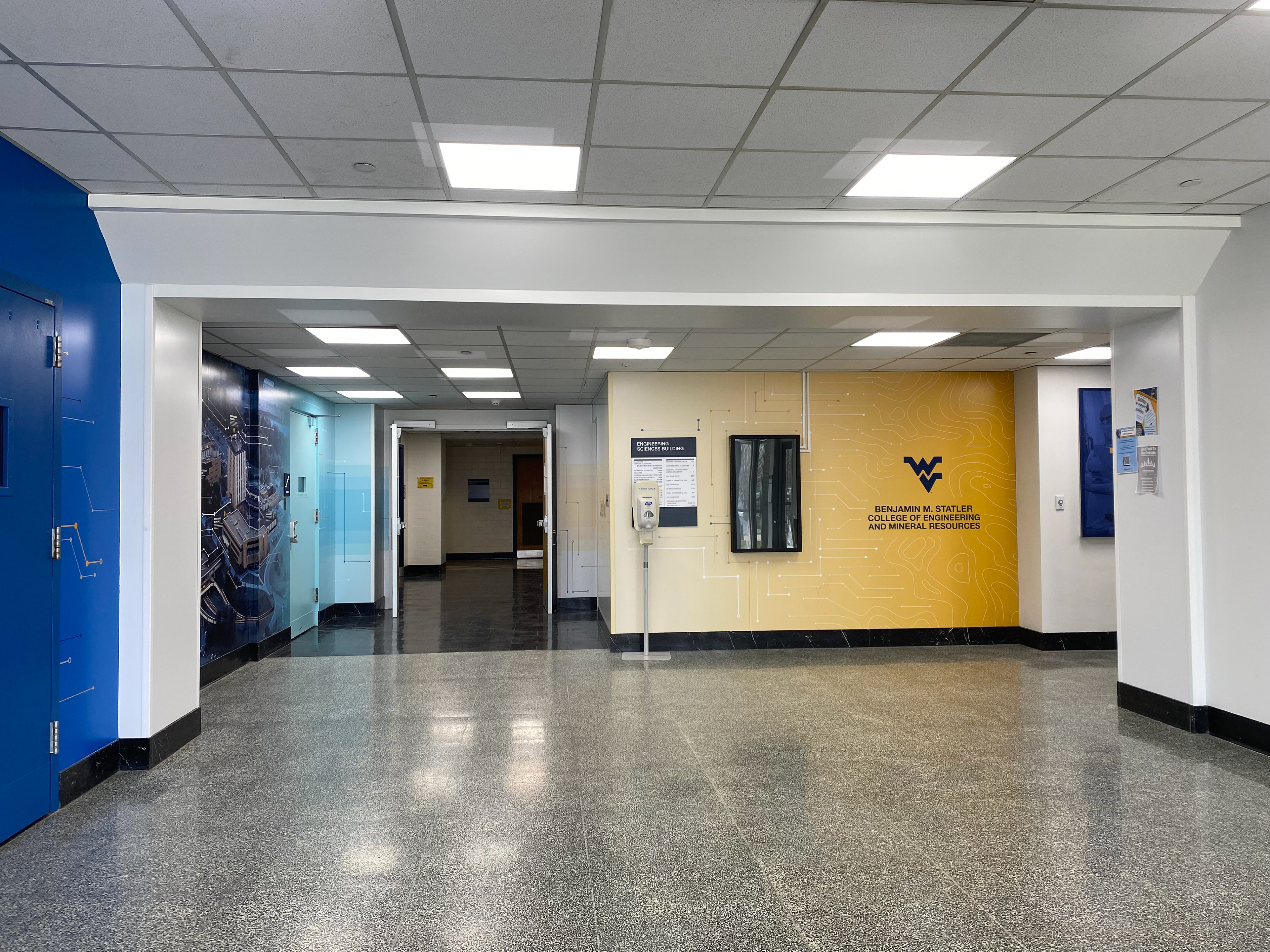 An overview of all walls as they appear after the vinyl has been installed; the space is much brighter and colorful, and no longer swallows the light.