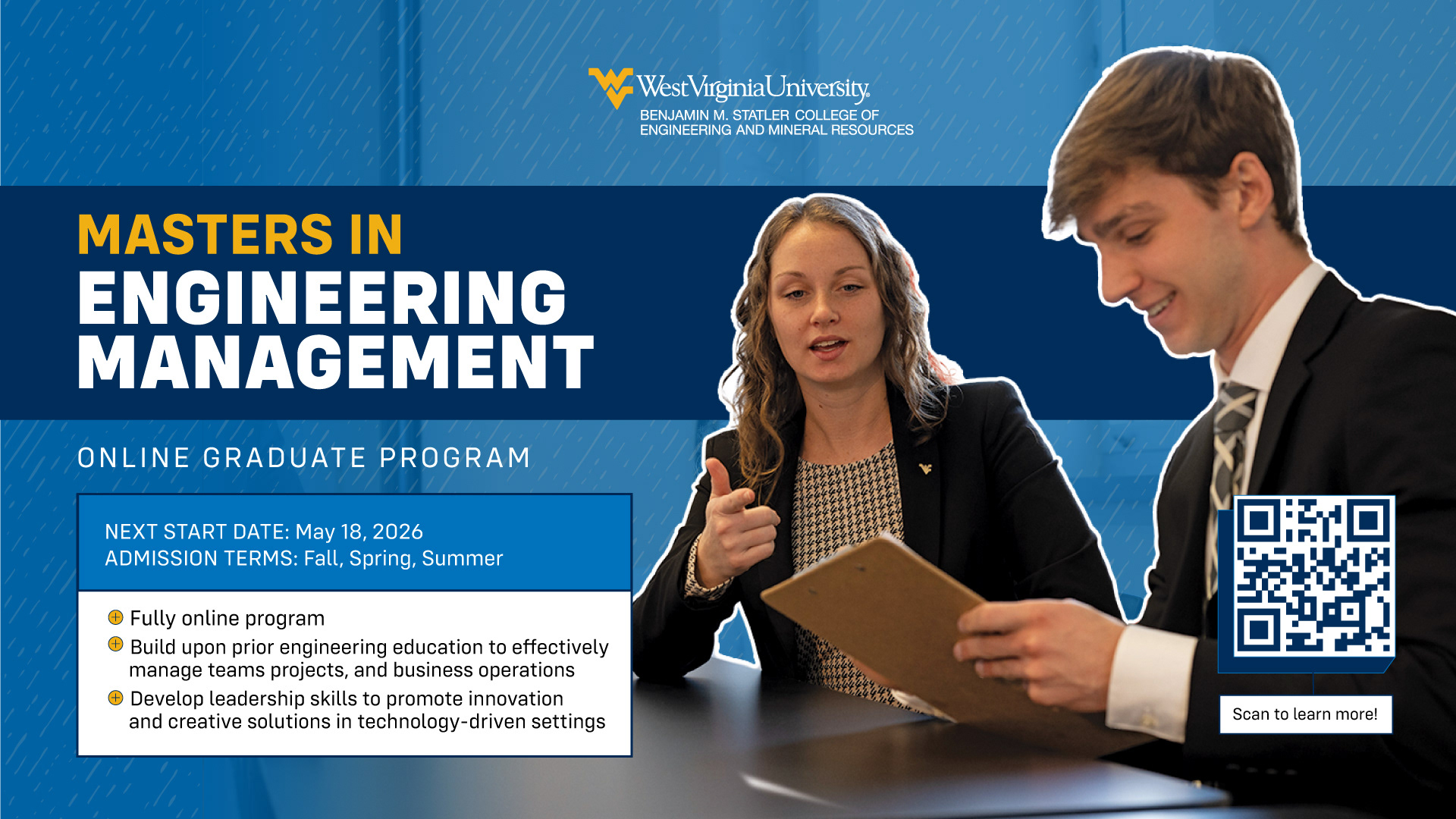 Masters in Engineering Management. A female student explains notes on a clipboard to a male student, both in business professional attire.
