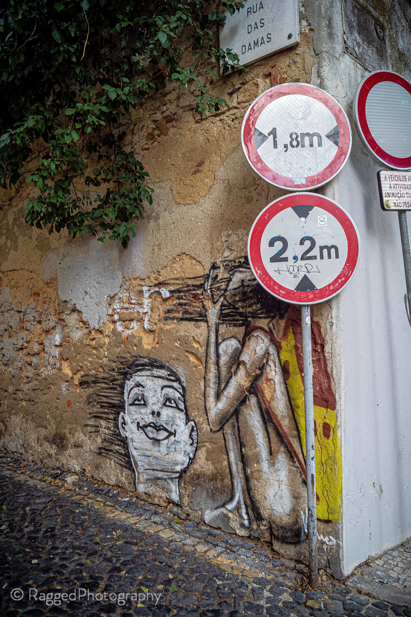 Lisbon | graffiti with signposts