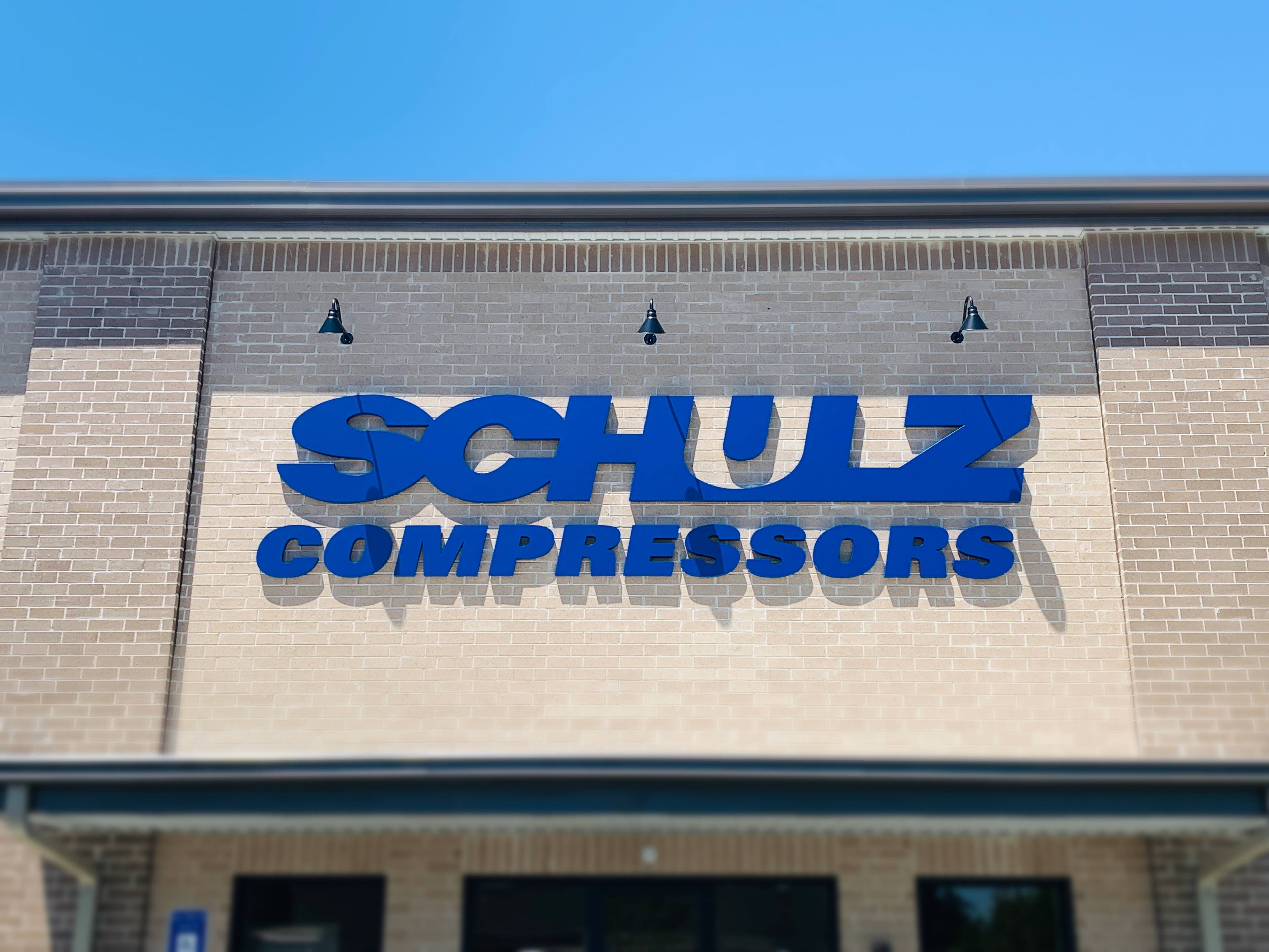 Witness the radiance of Schulz of America's front office sign in the nighttime, where strategic illumination transforms it into a beacon of corporate excellence, expertly crafted by S2dm Graphic Design.