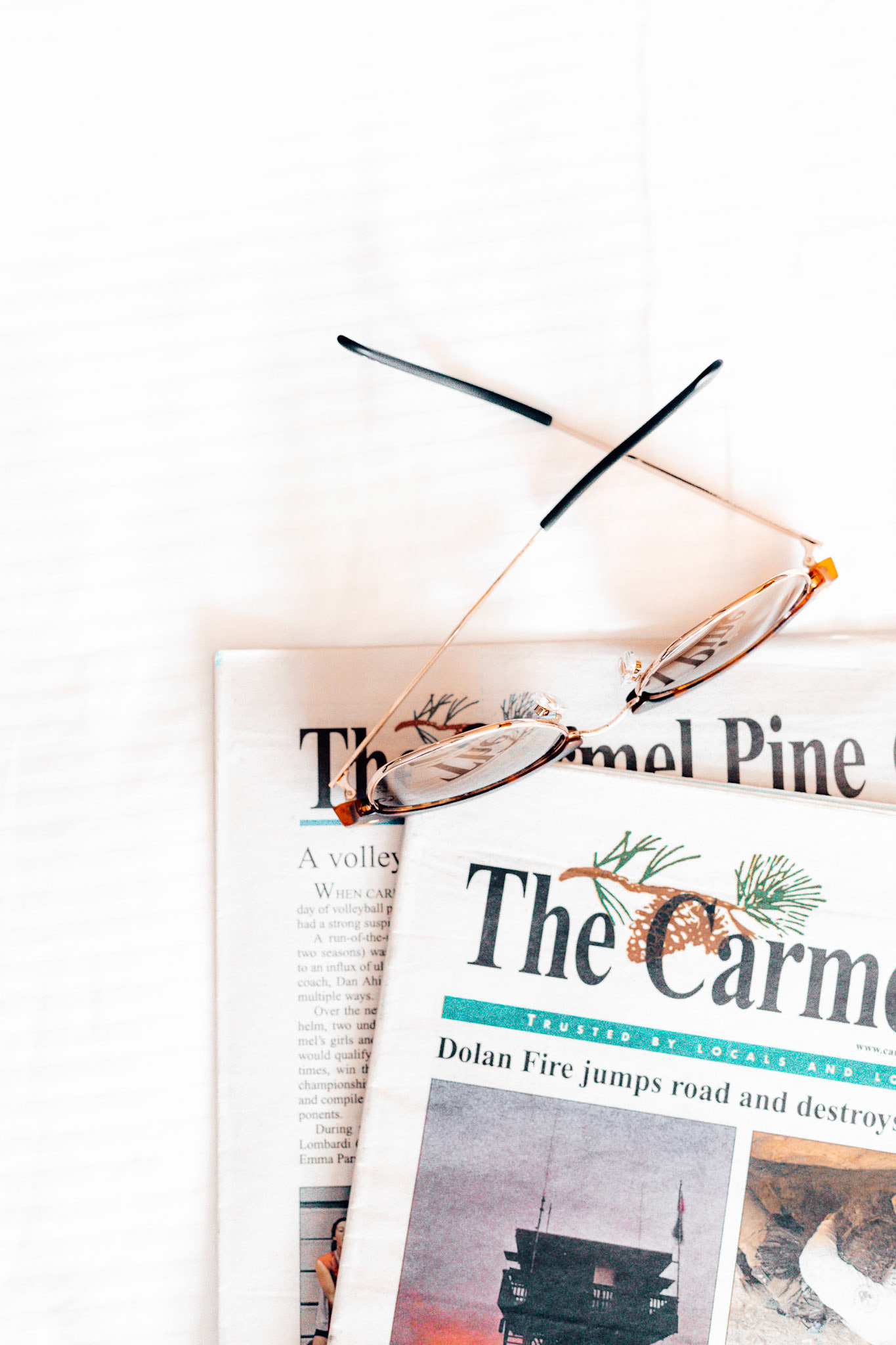 Carmel Pinecone Sunglasses on Newspapers