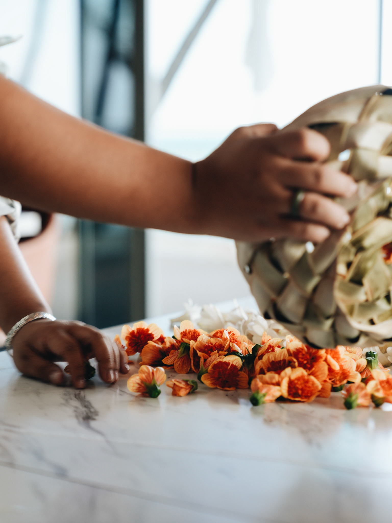 Person Arranging Flowers on Table