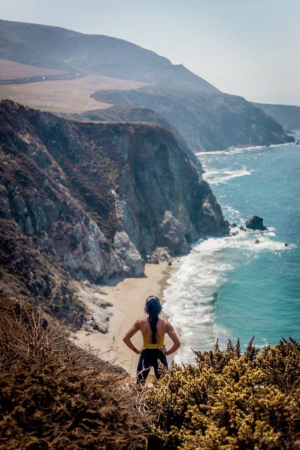 Person Overlooking Coastal Cliffs