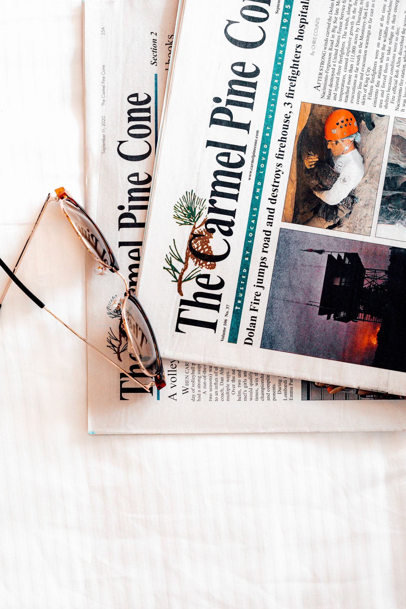 Carmel Pinecone Glasses &amp; Newspapers on Table