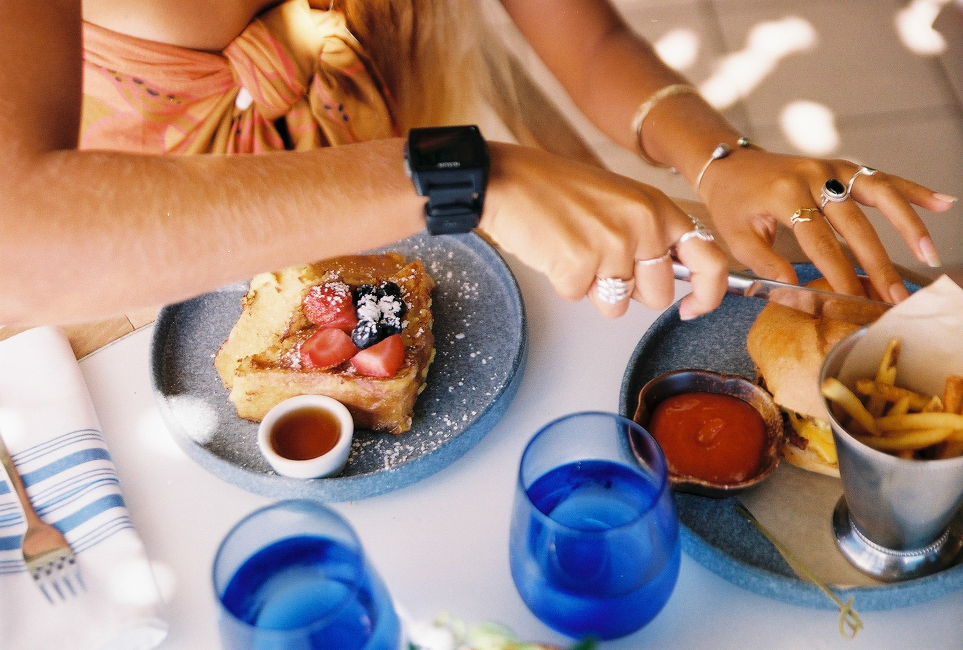 Person Cutting Food at Table
