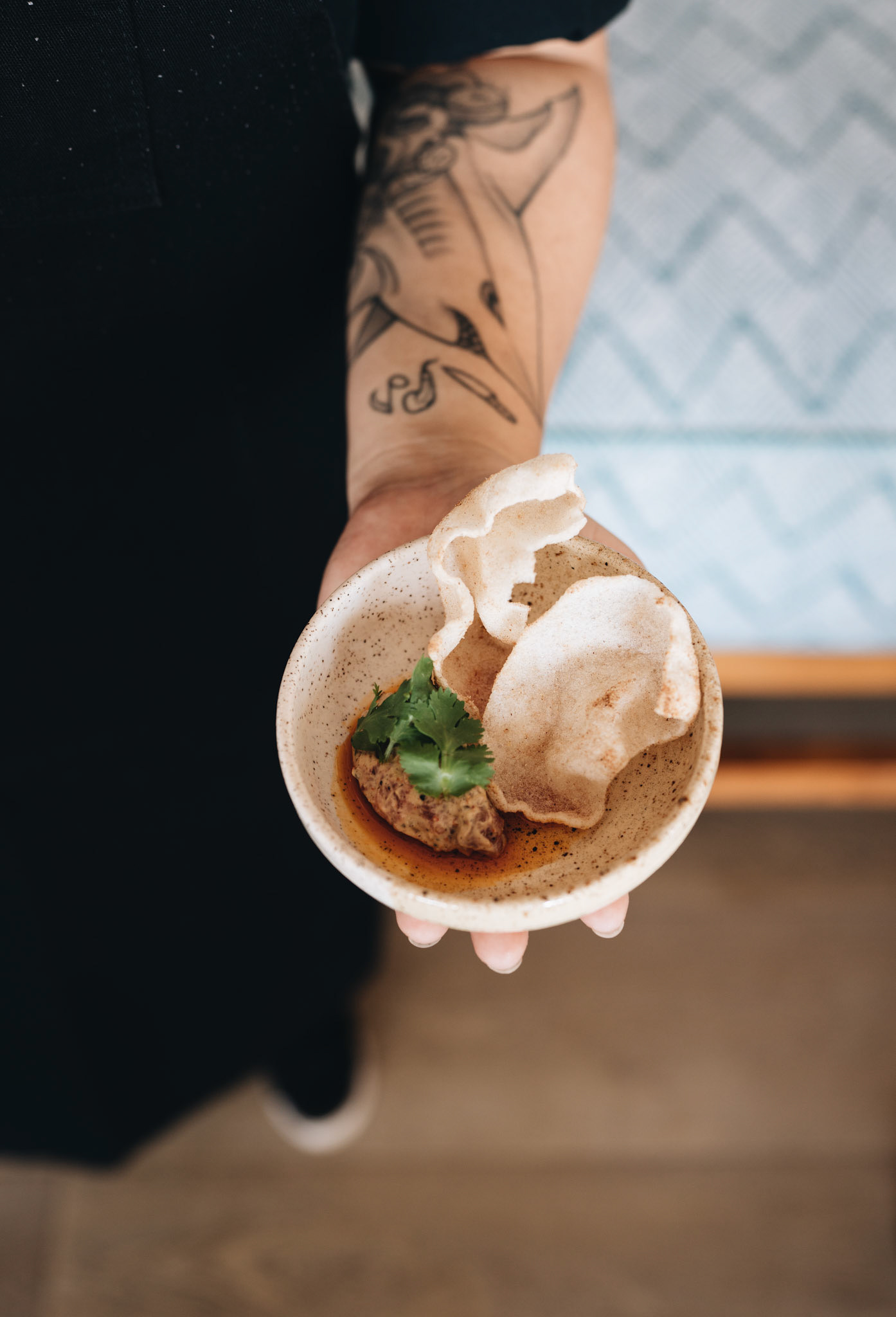 Hand Holding a Bowl of Food