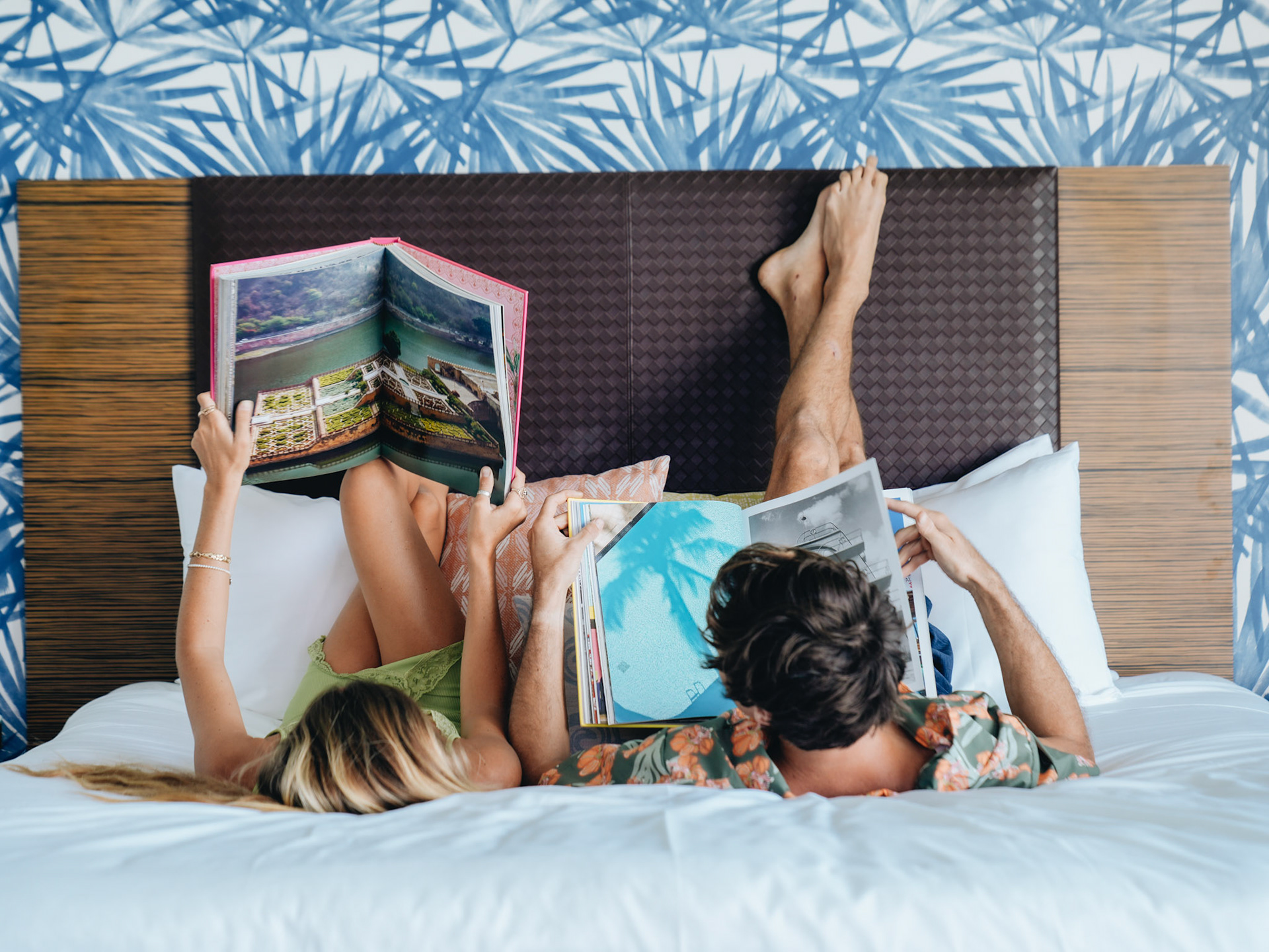 Couple Reading Travel Books in Bed