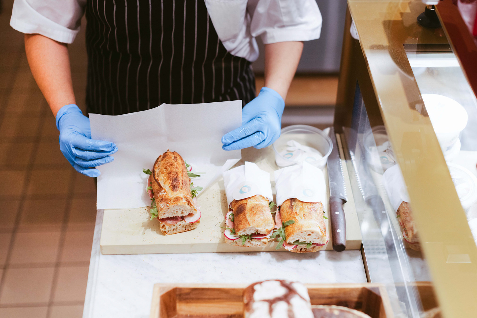 Person Preparing Sandwiches In a Deli