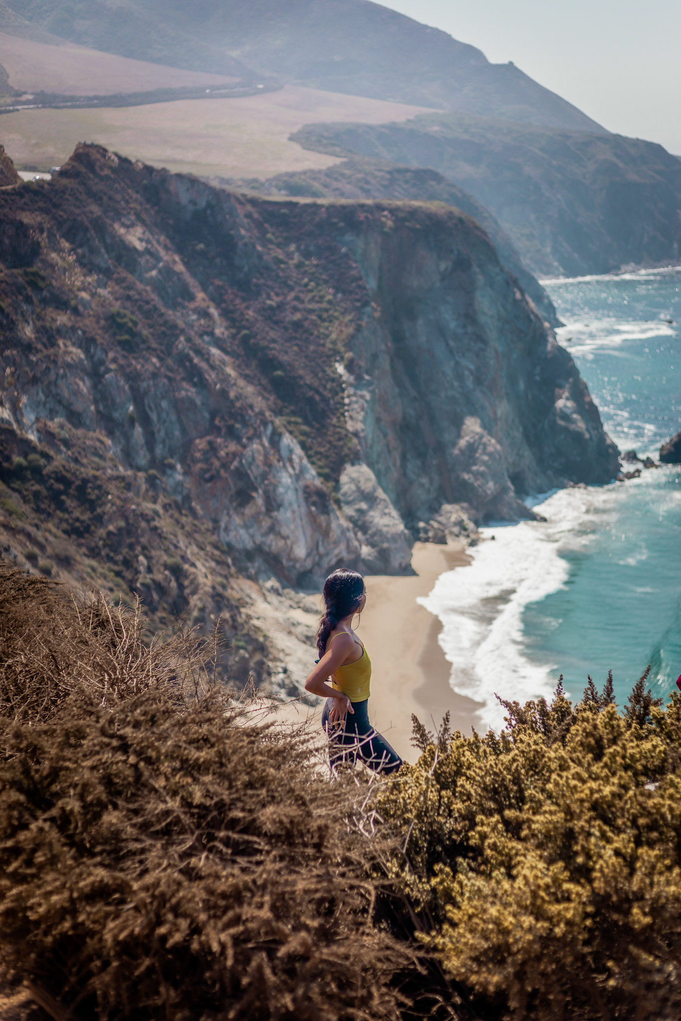 WomanOverlooking Coastal Cliffs