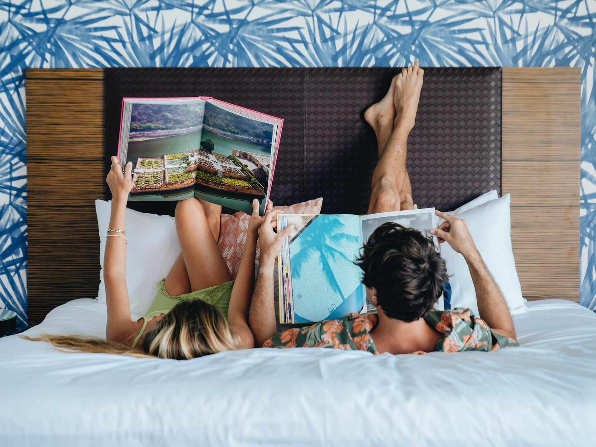 Couple Reading Magazines in Bed