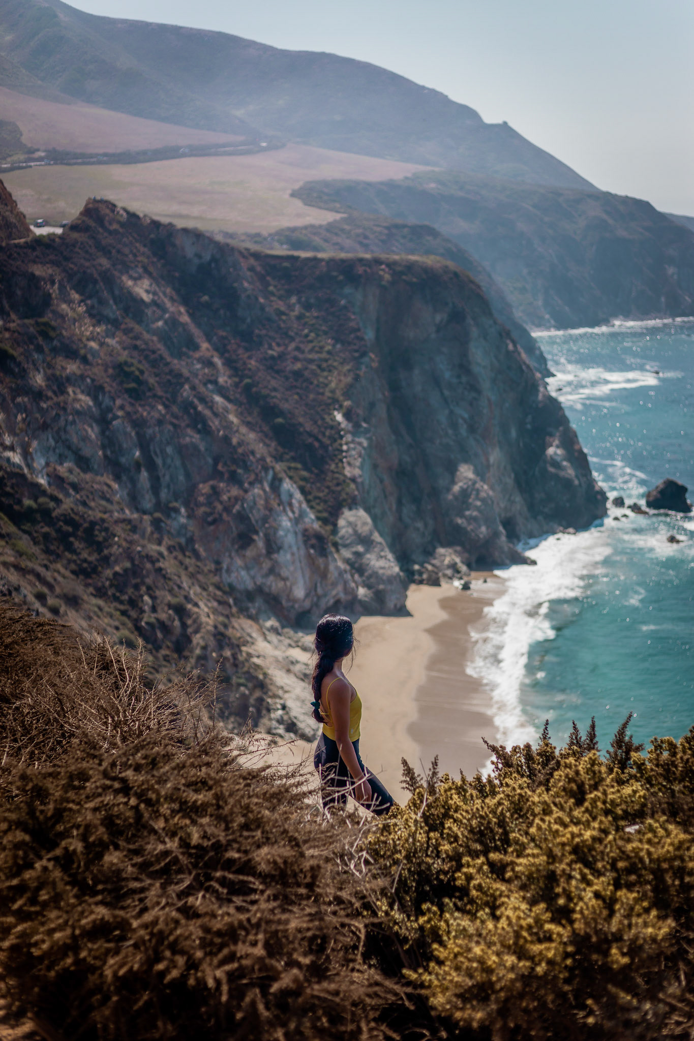 WomanOverlooking Beach &amp; Cliffs