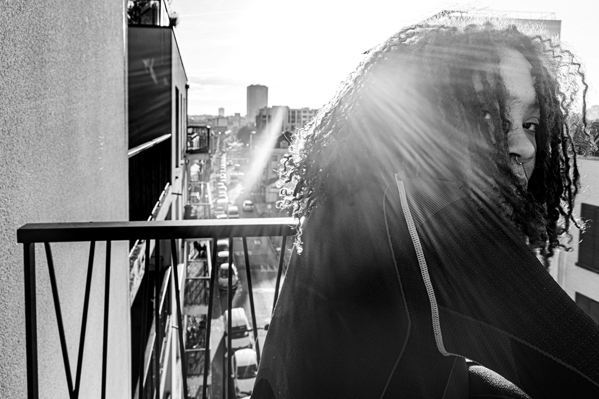 Rose Oyemi’s Balcony, Aubervilliers, Paris. January 18th 2026. Kael, an artist and member of the BlackoutGeneration, basks in the winter sun on Rose Oyemi’s balcony.