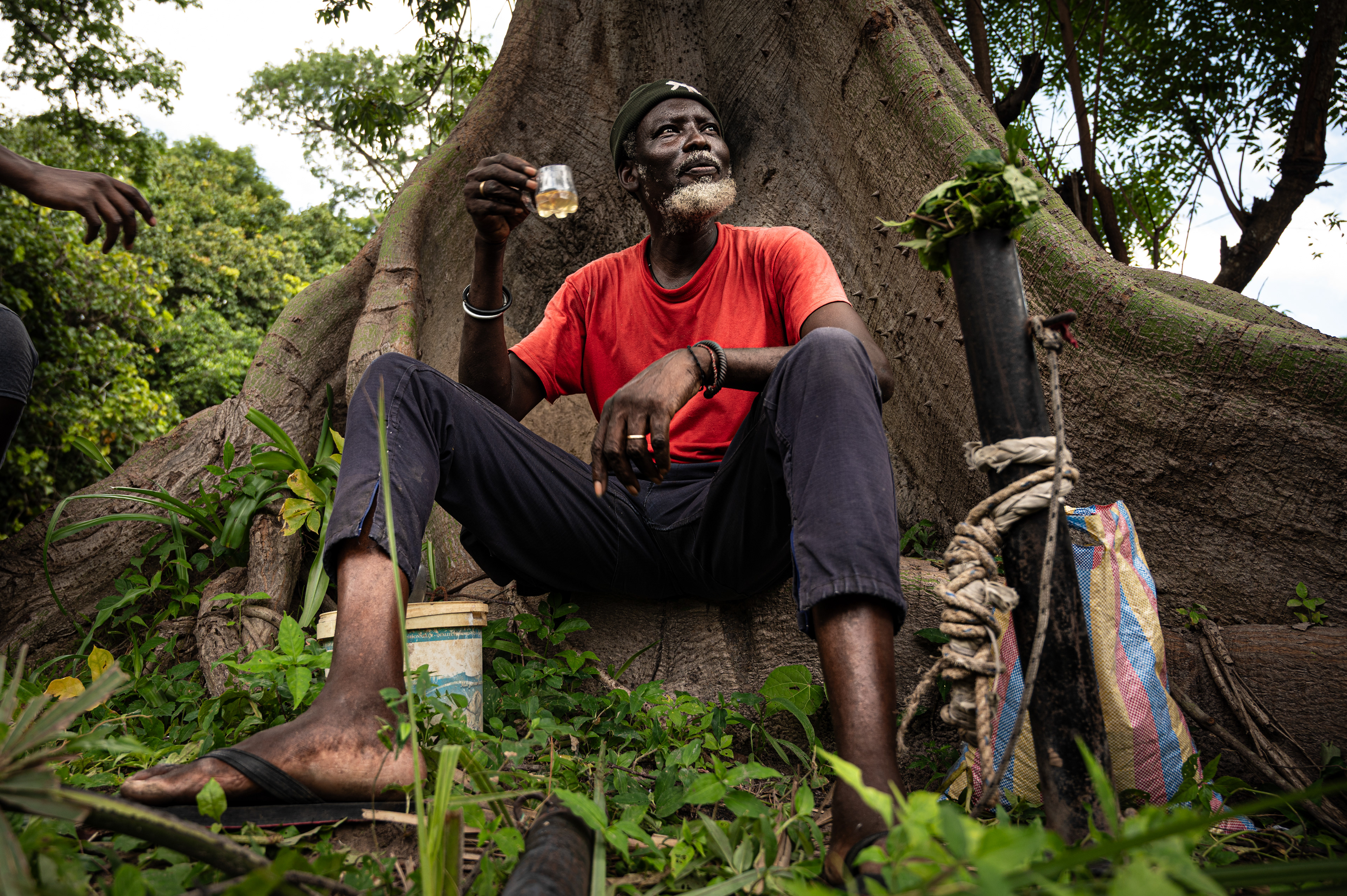 A bomber drinks alcohol during the Boukout ceremonies in Sengalene village, Casamance region, Senegal. August 22, 2026.