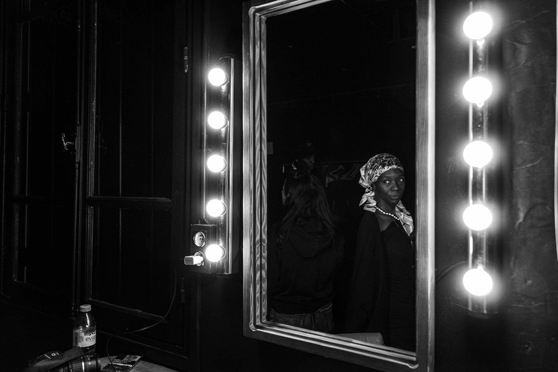 "Leizart" production studio, 20th arrondissement, Paris. October 19th, 2025. Rose Oyemi, member of the collective, looks at her reflection on the set during the preparation of a videoclip. 