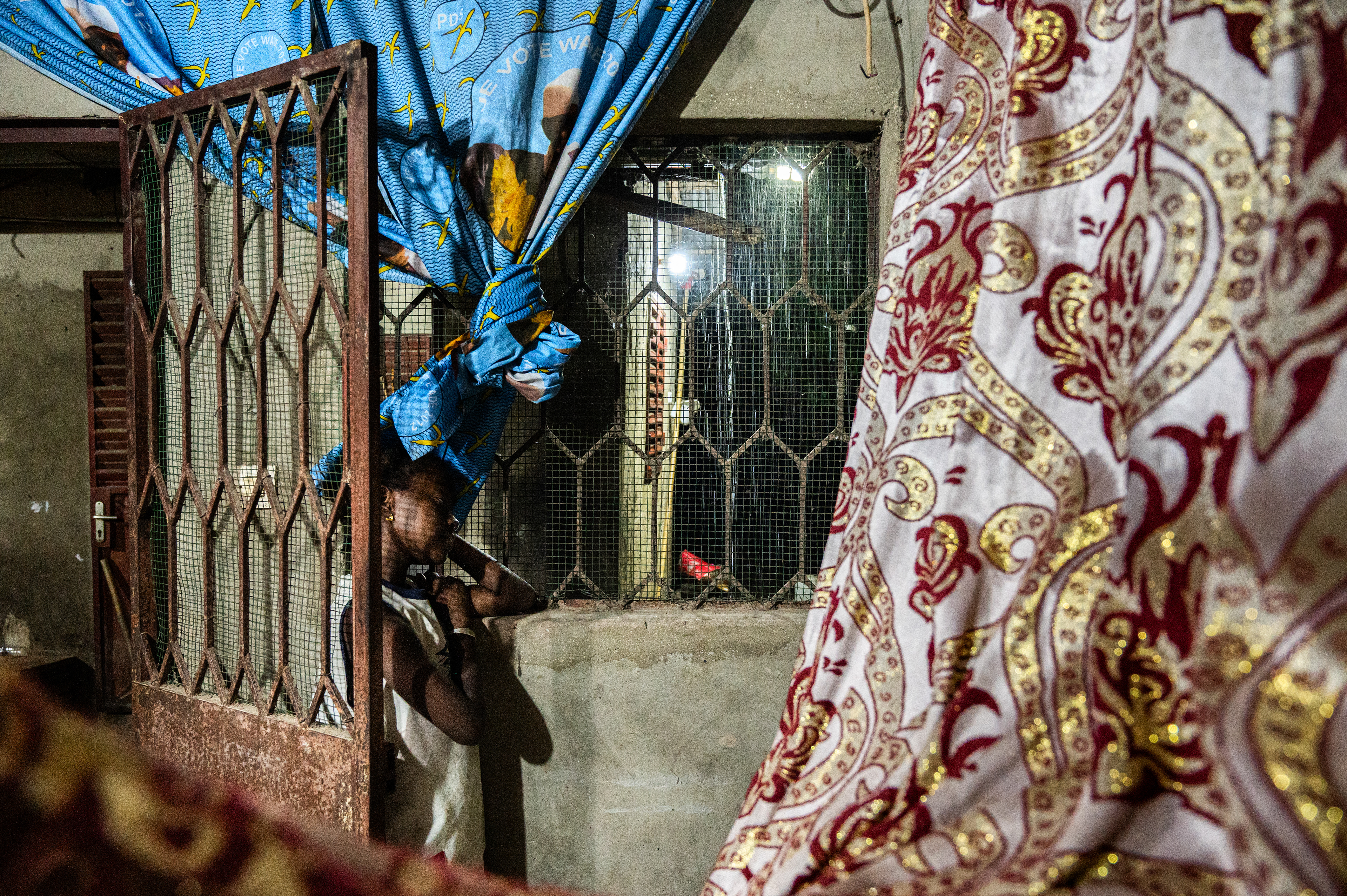 Noura watches the rain falling during the rainy season in Sengalene village, Casamance region, Senegal. August 8, 2026.