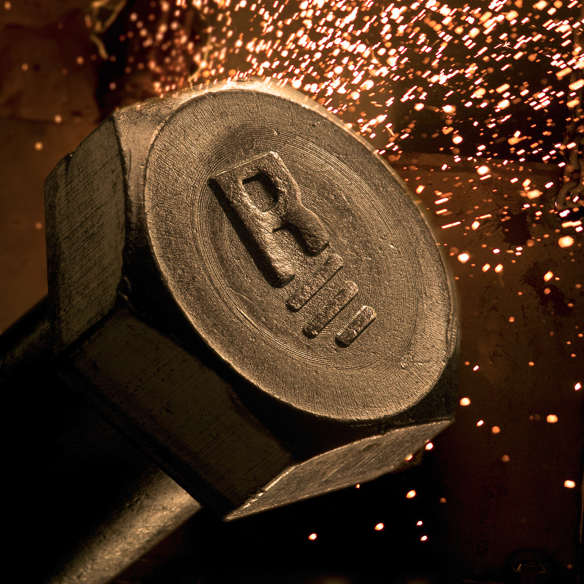 Studio illustration done as an in-camera composite of a Rockford Products chromium steel hex headed bolt & welding sparks to convey manufacturing power.