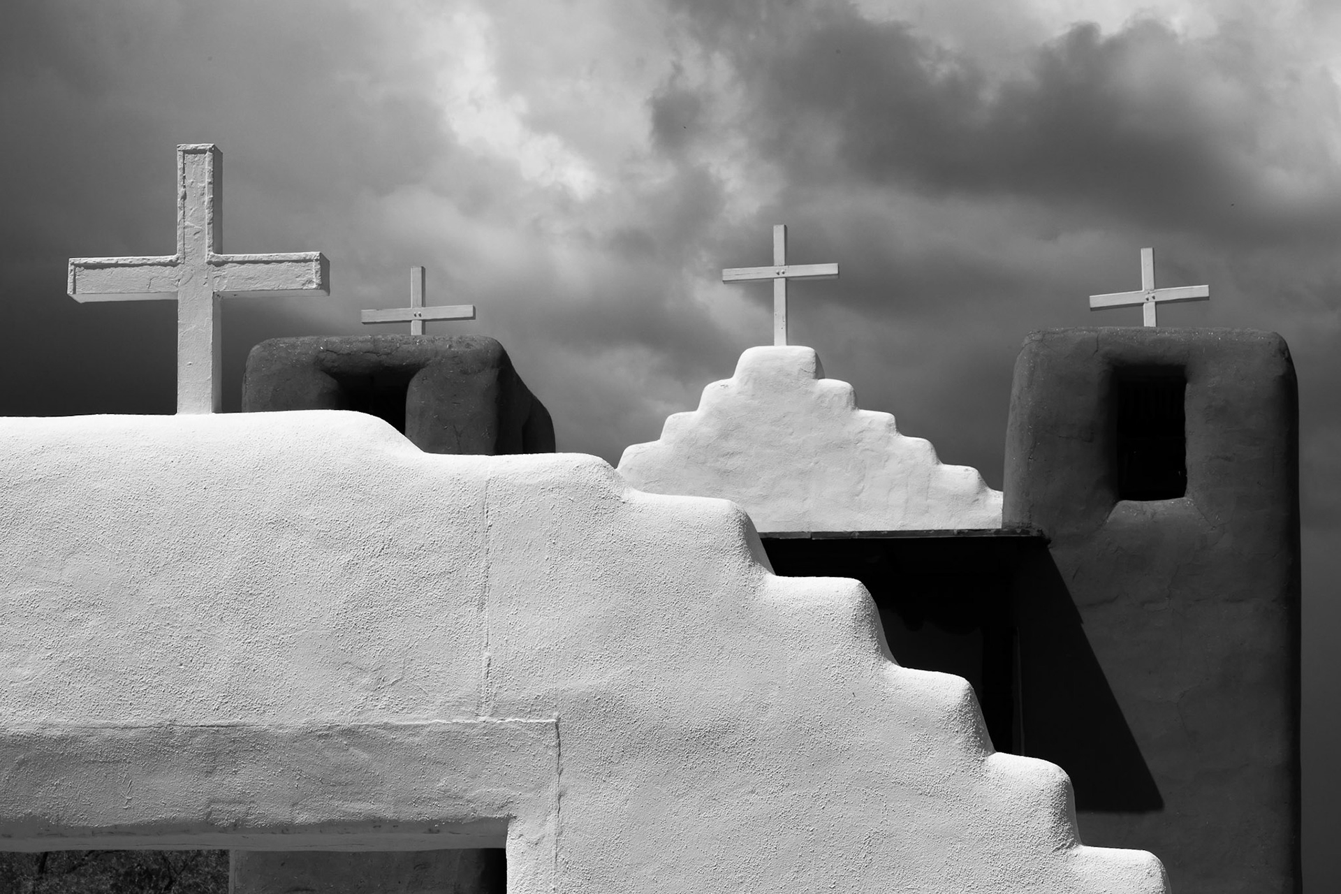 The new San Geronimo Chapel, Taos Pueblo, NM.  The Pueblo of Taos is approximately 1000 years old and is inhabited by a Northern Tiwa speaking tribe of the Pueblo People.  The original San Geronimo Church was constructed by the Spanish around 1620 against the will of the native people.  Over the next 60 years the church was destroyed by native people twice, killing one or more priests each time.  The latest was in 1680 during the "Pueblo Revolt".  This latest version of the church was built in 1850 on a different spot, leaving the remnants of the prior church where it fell several hundred yards away.