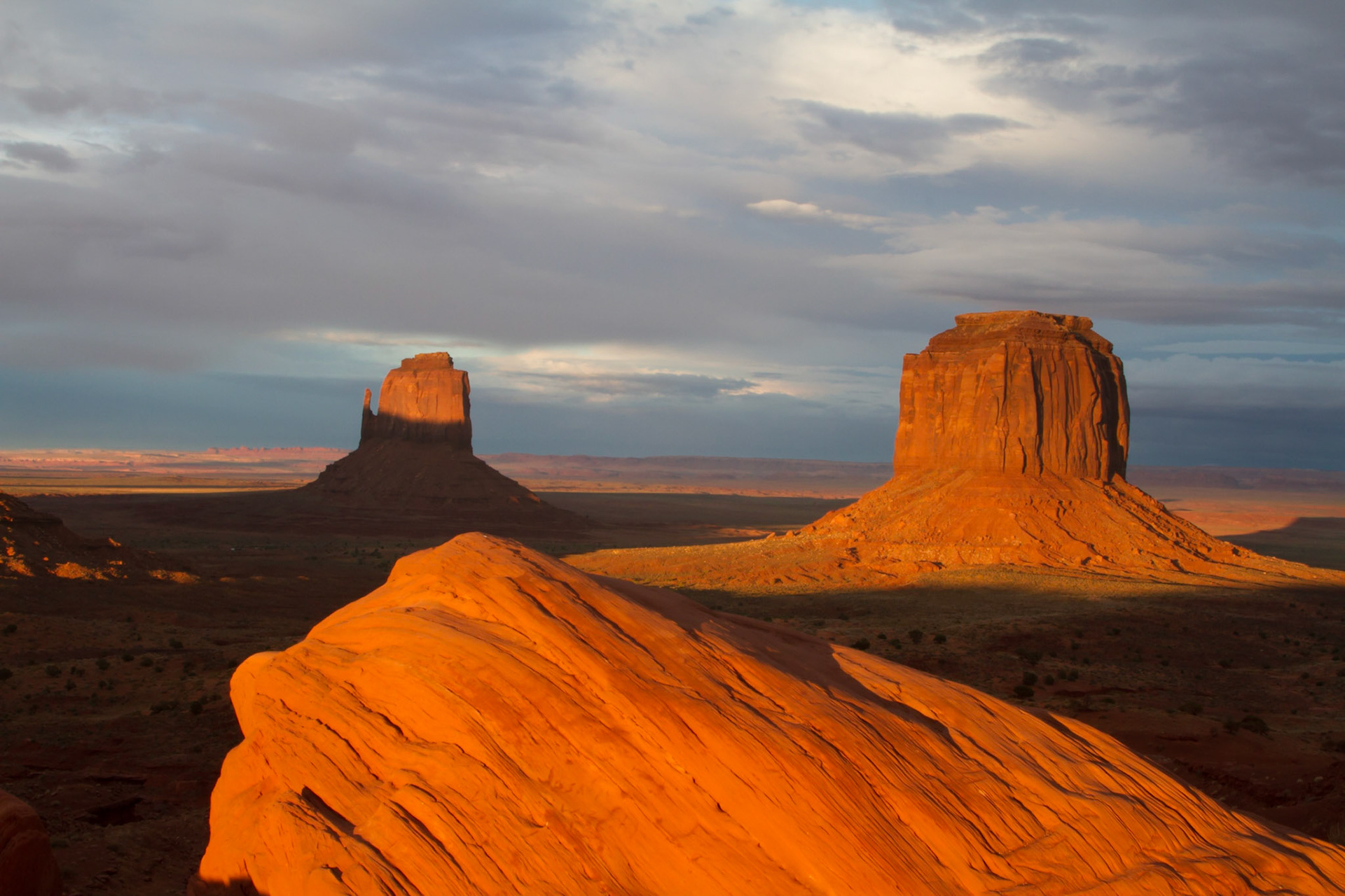 Monument Valley is part of the Colorado Plateau characterized by a cluster of vast sandstone buttes, the largest reaching 1,000 ft above the valley floor. It is located on the Arizona-Utah state line near the Four Corners and lies within the Navajo Nation Reservation and is designated a Navajo Tribal Park.