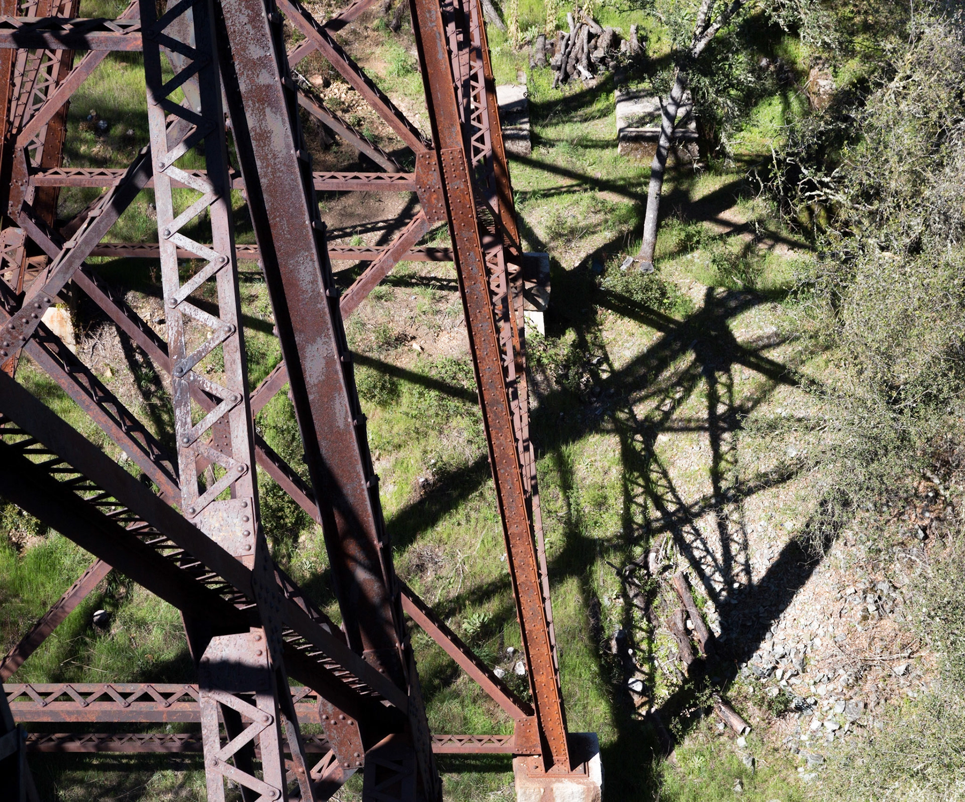 Steele framework and shadow of old railroad trestle supporting elderado Trail crossing Weber Creek on old railraod trestle, Placerville, CA 2016