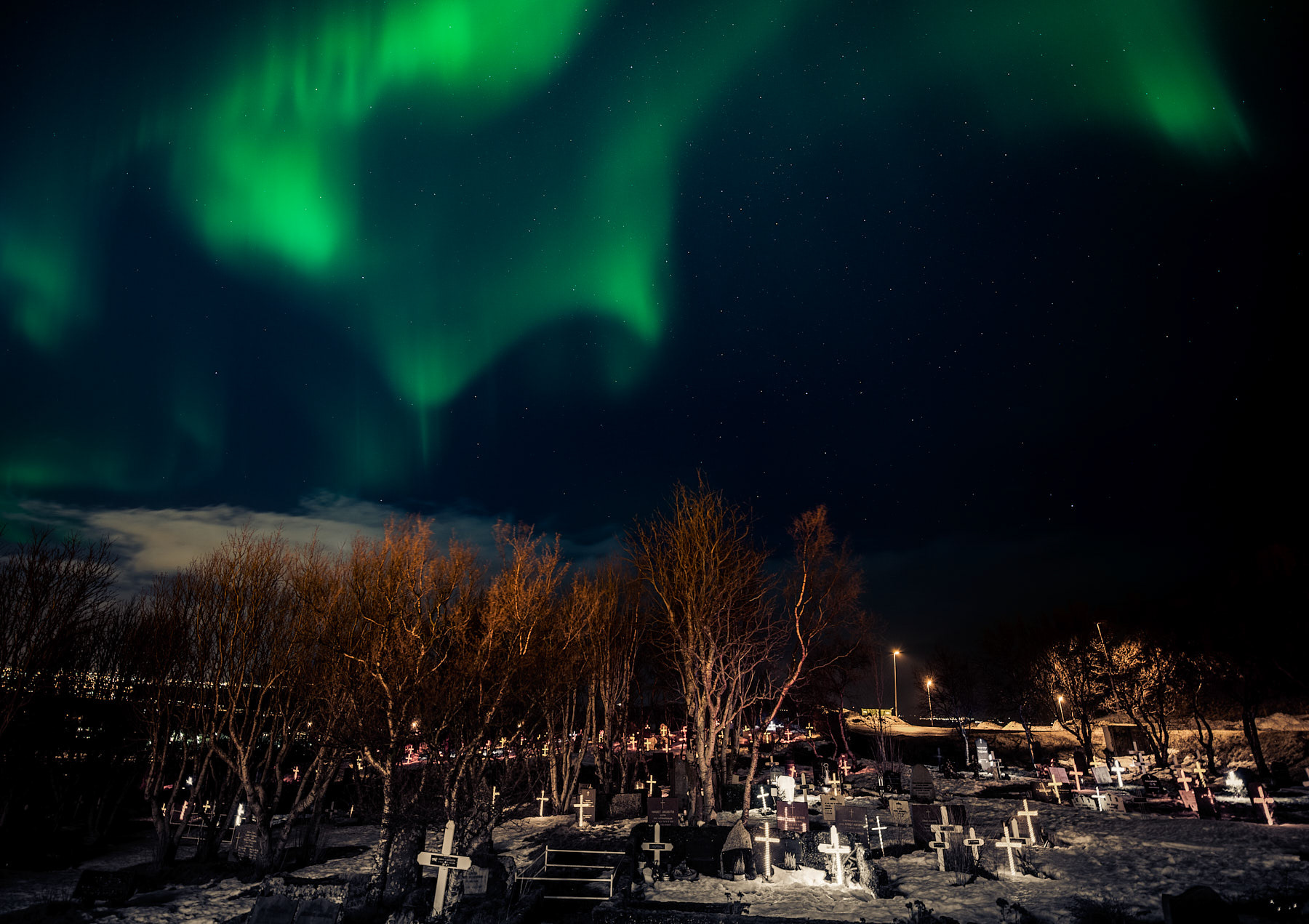 A photo of a cemetery during Christmas in Reykjavic Iceland.