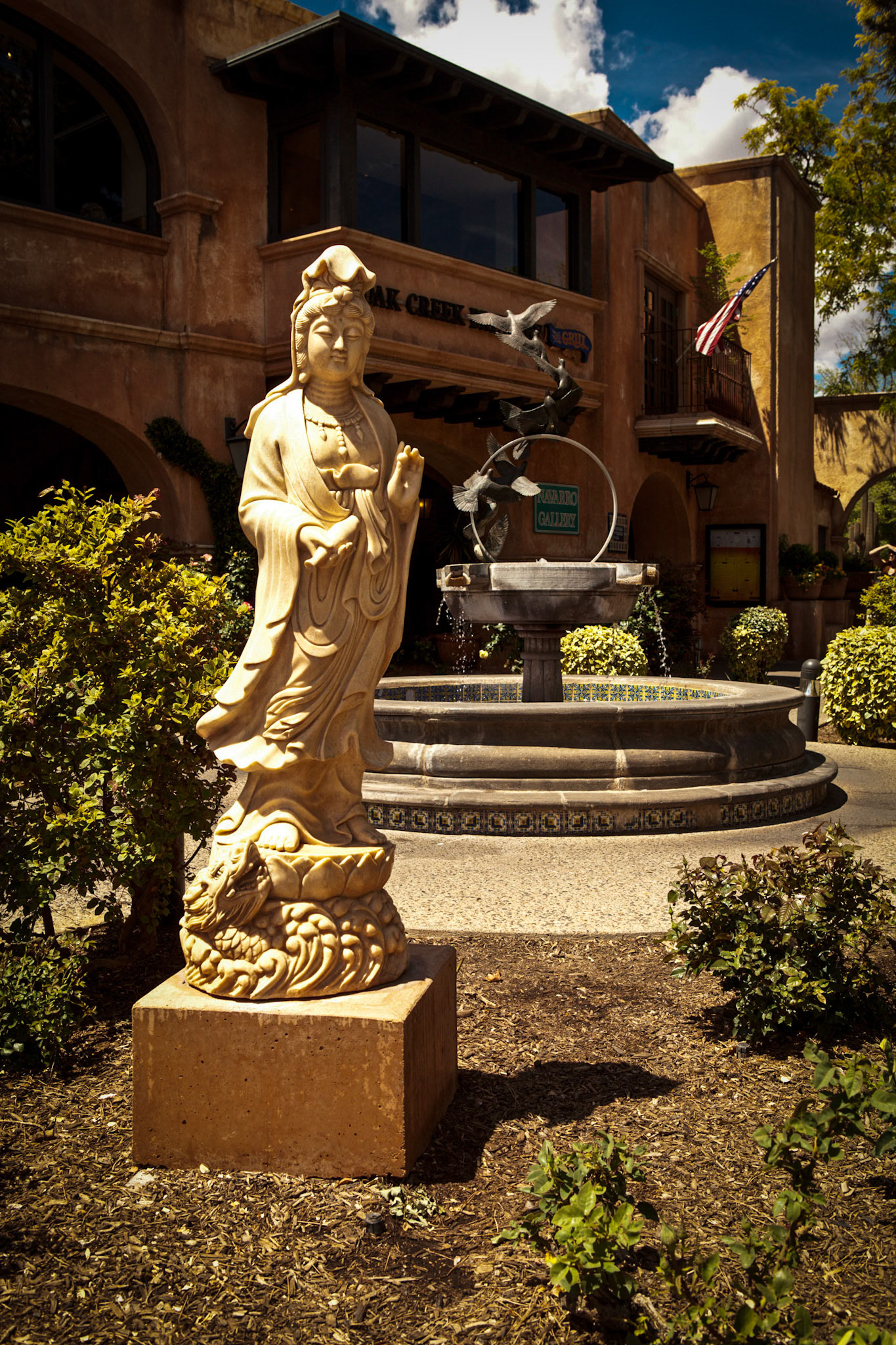 A female Buddha statue stands in the courtyard at Tlaquepaque.