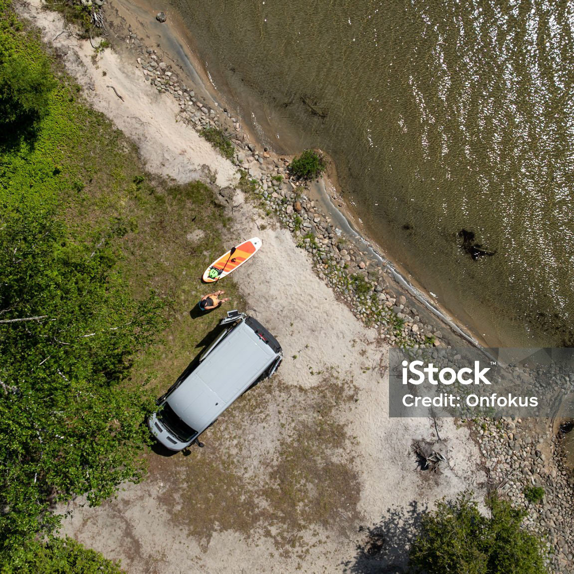 Aerial View of a Man Relaxing Close to a Lake With Camper van During Summer, The Laurentian Mountains, Quebec, Canada.