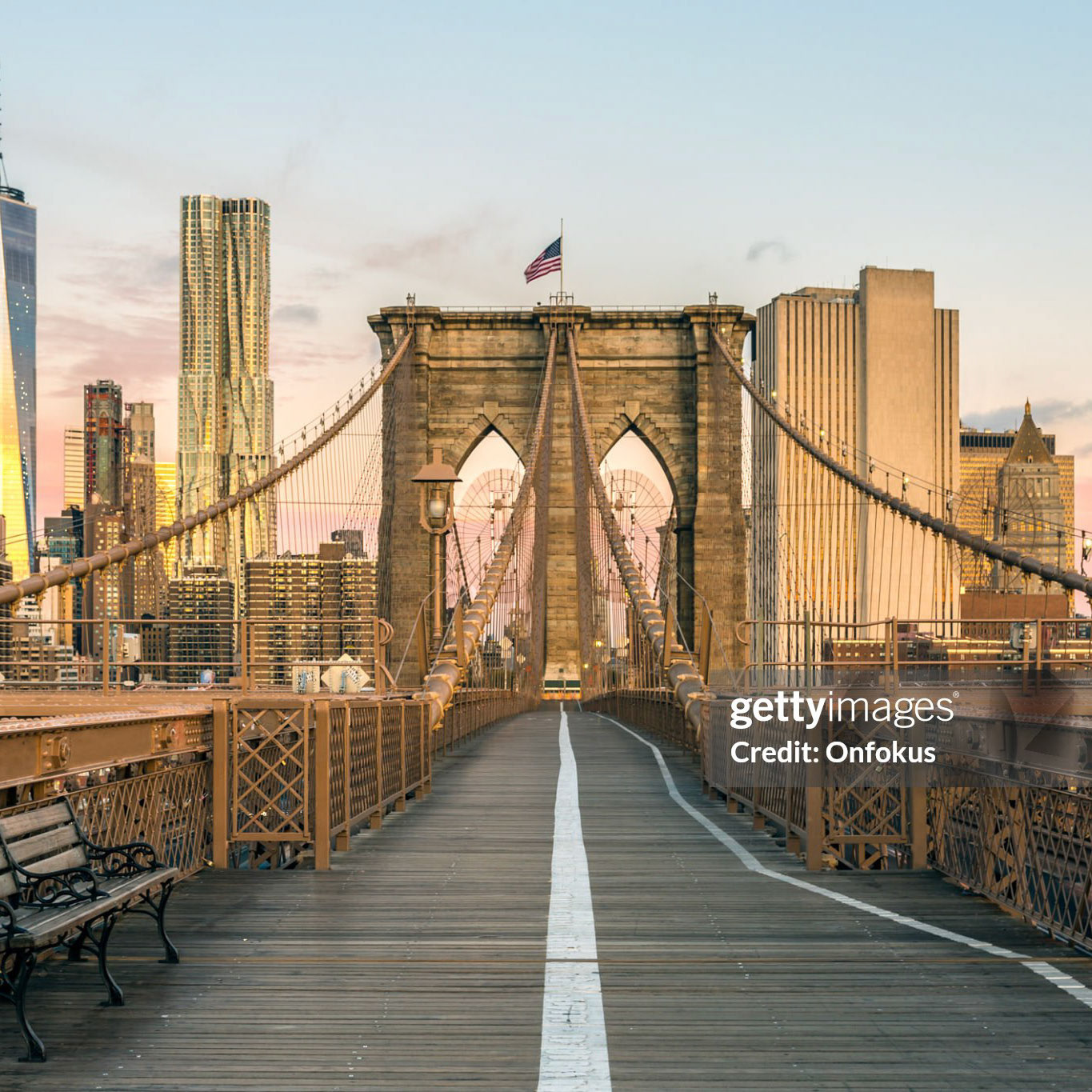 The Famous Brooklyn Bridge at Sunrise, New York City, USA. The sun is rising over Brooklyn on this beautiful day of Autumn
