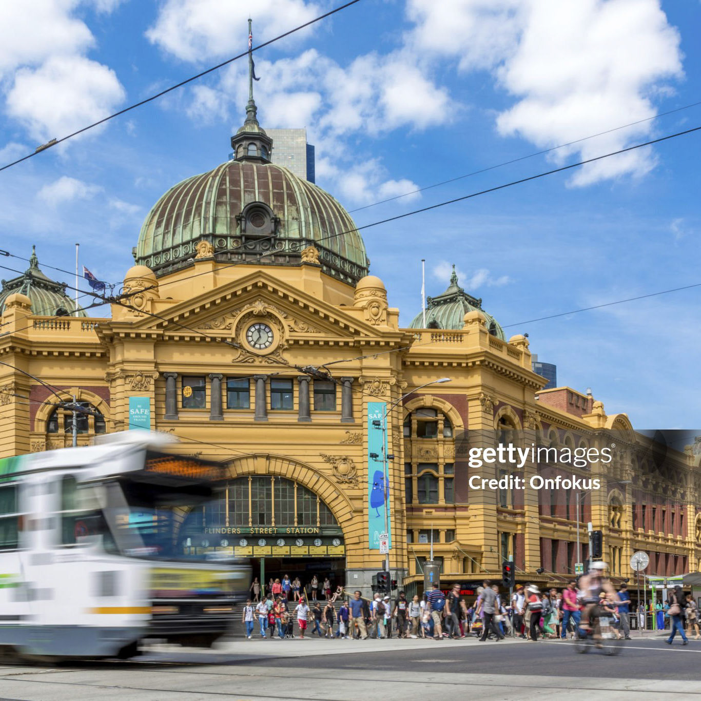 Melbourne, Australia- February 14, 2013: Pedestrians and cylers at the iconic Flinders Street Station in Melbourne, Australia