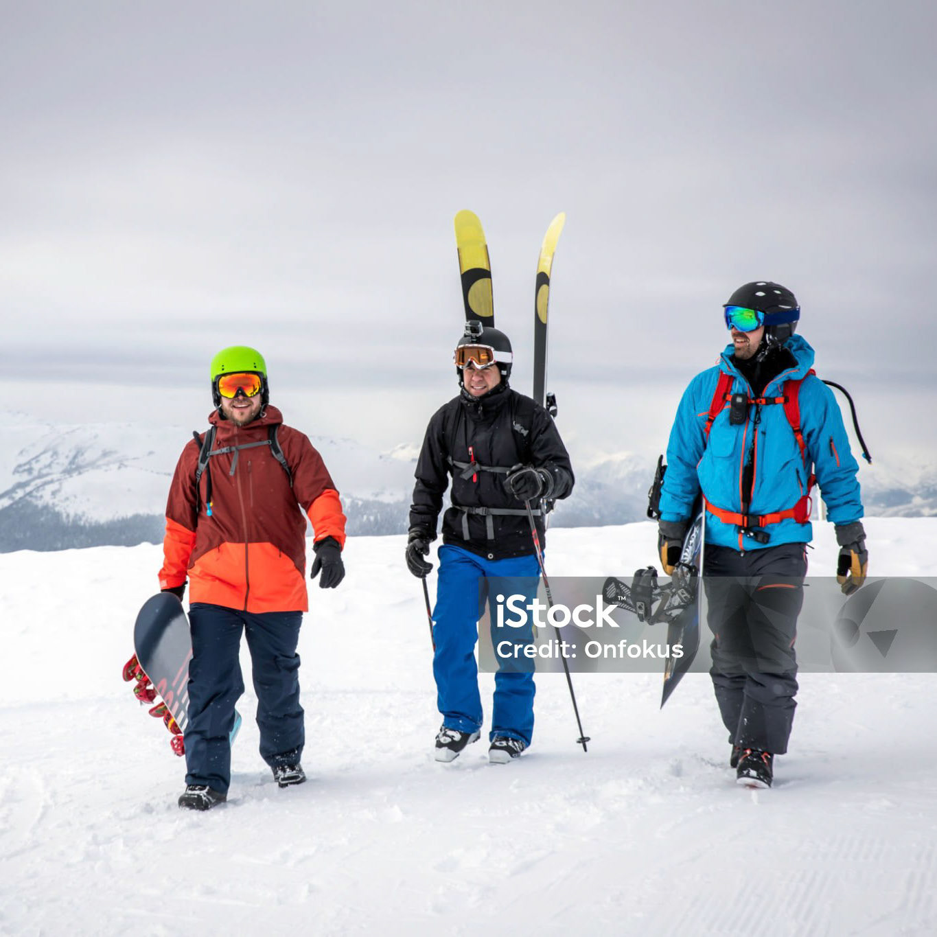 Backcountry Skier and Snowboarders hiking on Mountain Summit