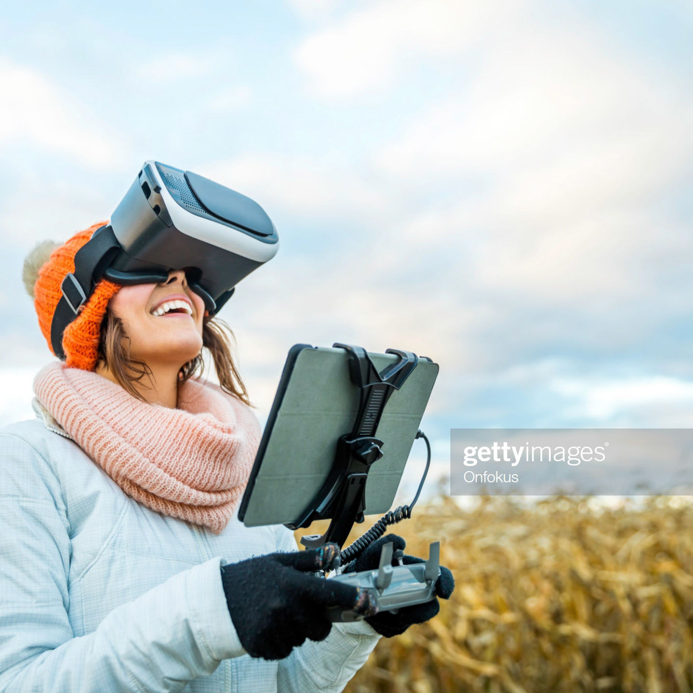 Woman Pilot Using Drone Remote Controller with a Tablet Mount and Virtual reality Goggles