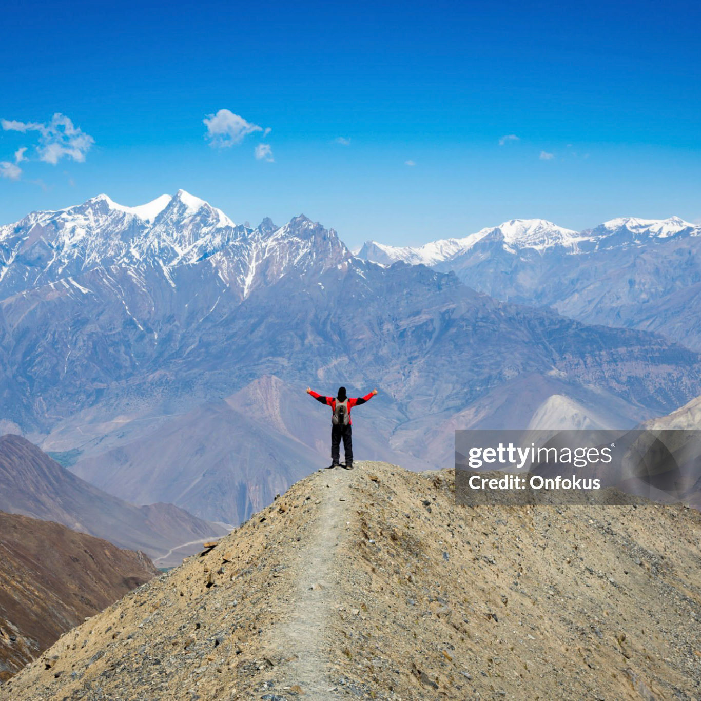 Man hiker with arms raised Annapurna trek, Nepal