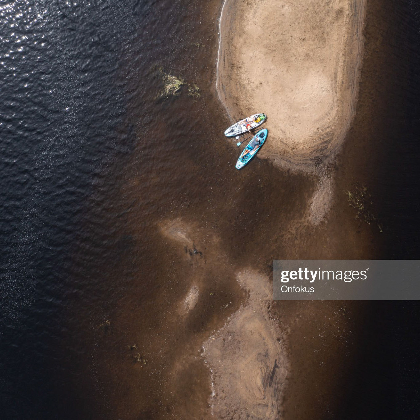 Aerial View of Family Resting on Sand Island After Paddleboarding Adventure. Rivière Jacques-Cartier, Quebec, Canada