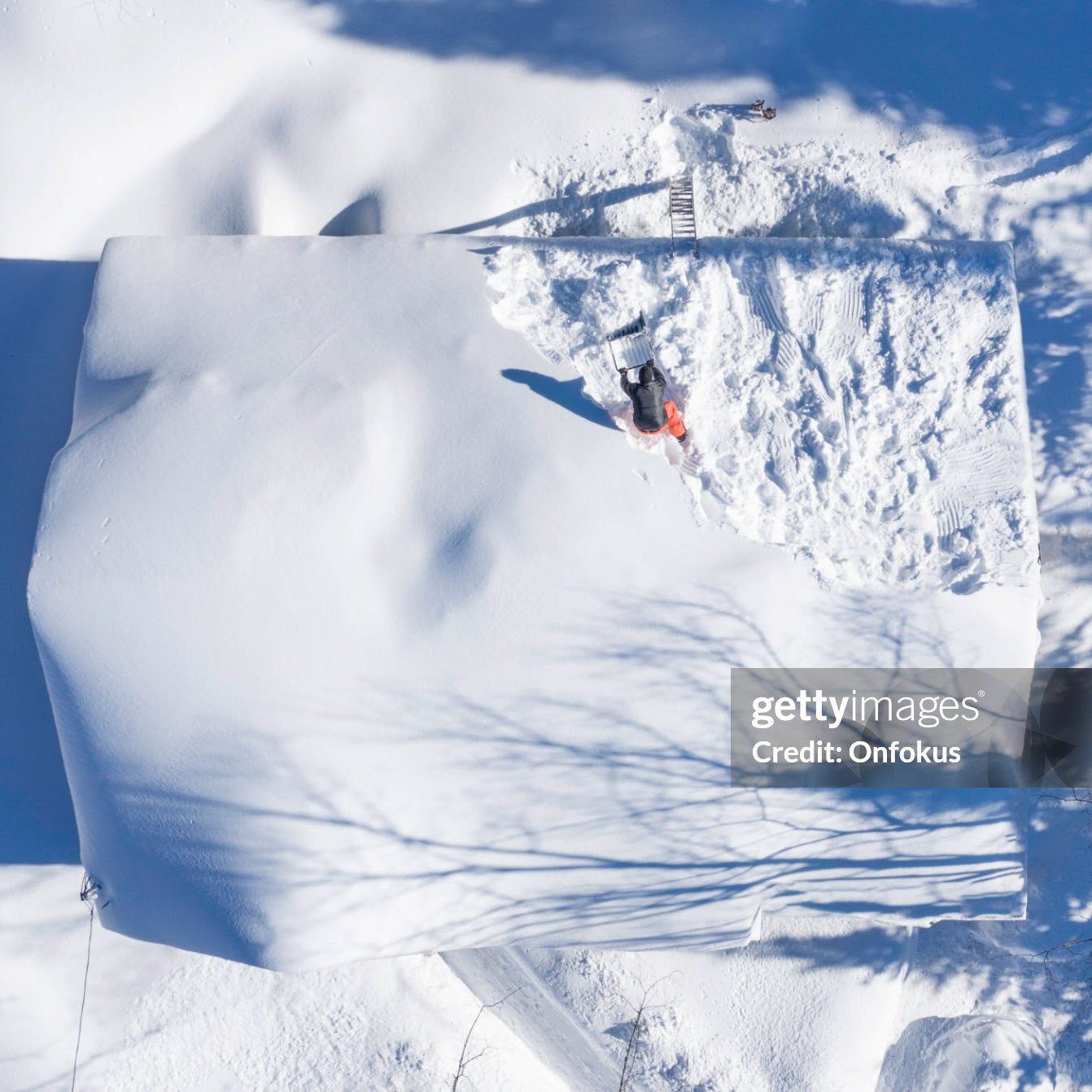 Aerial View of a Man Shoveling Snow From a House Roof Top After Snowstorm, Quebec, Canada