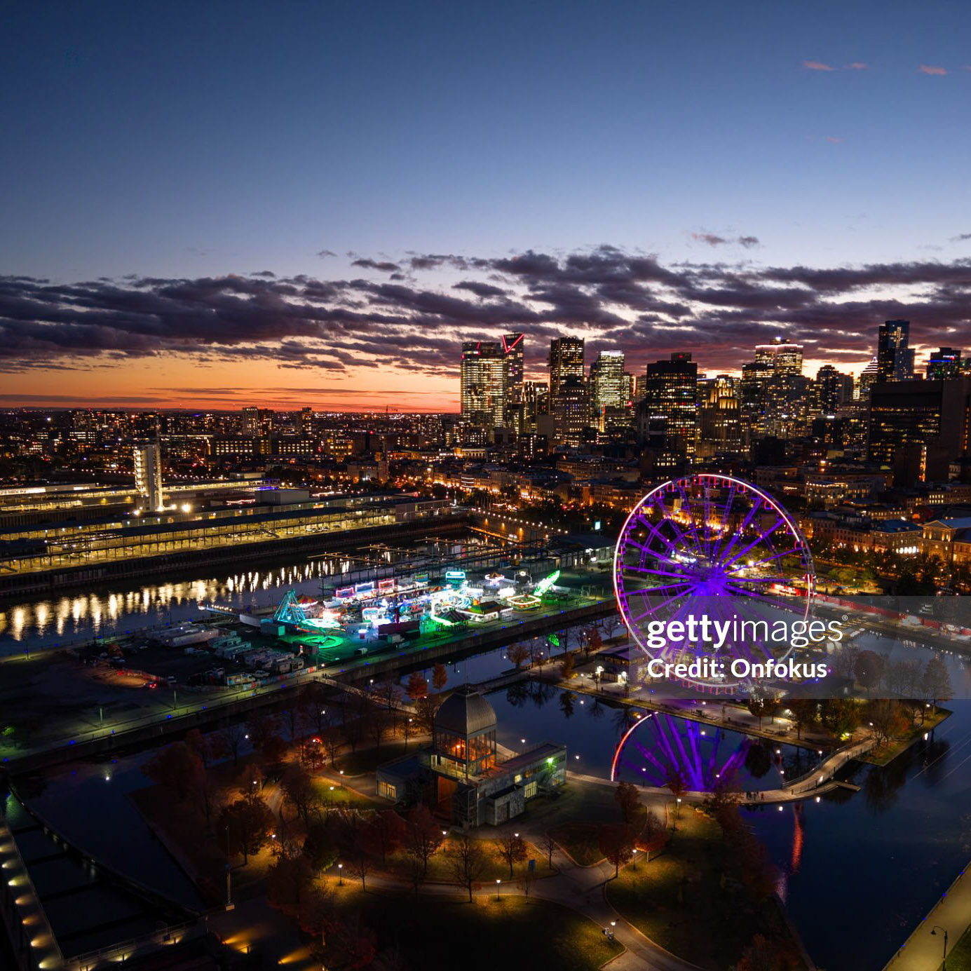 Aerial View of Montreal Cityscape During Autumn Season, Quebec, Canada At Sunset.Downtown Montreal Cityscape Aerial View and St. Lawrence River. Office towers, residential buildings, the harbor in Le Vieux-Montréal, the Clock Tower and La Grande Roue are visible in the video.