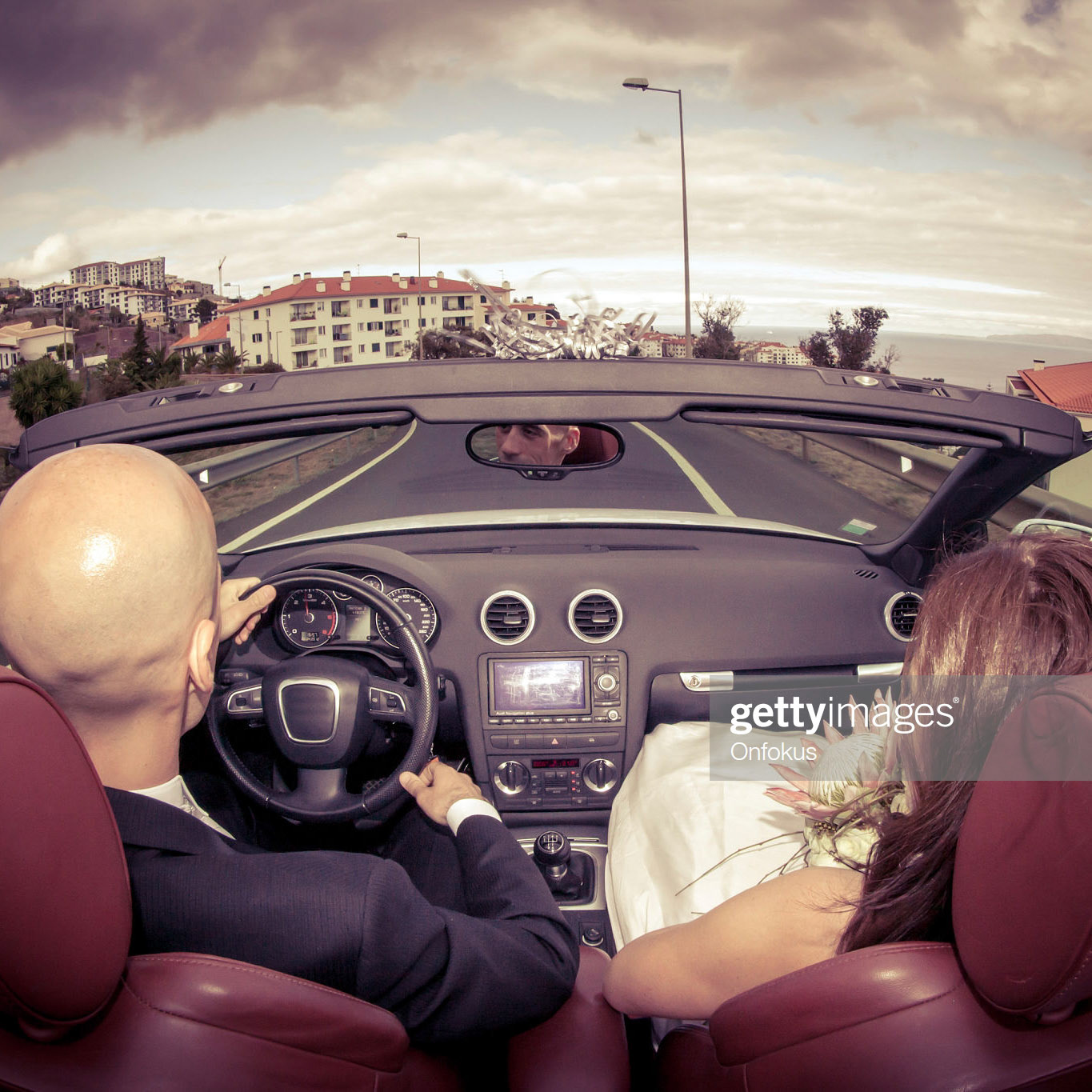 Romantic and attractive newly wed couple in convertible car