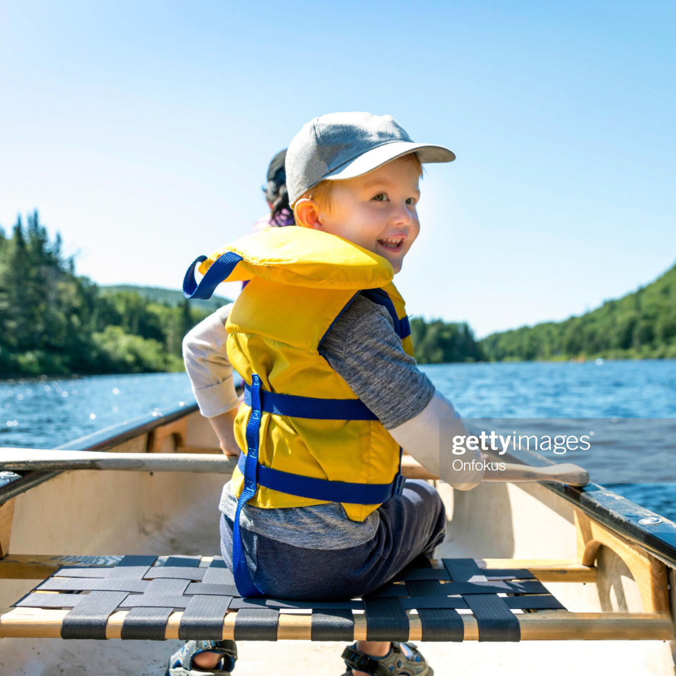 Little Redhead Boy Canoeing with his Family at Parc National de la Jacques Cartier, Quebec, Canada