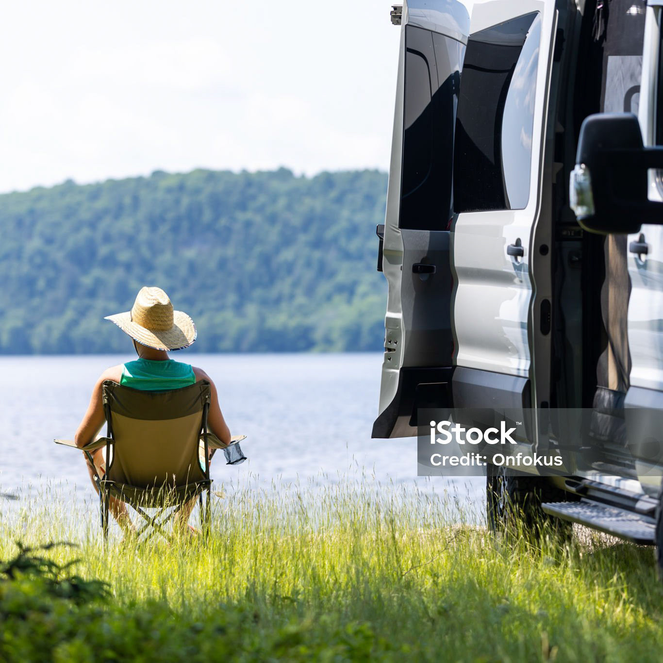 Man Relaxing Close to a Lake With Camper van During Summer, The Laurentian Mountains, Quebec, Canada.