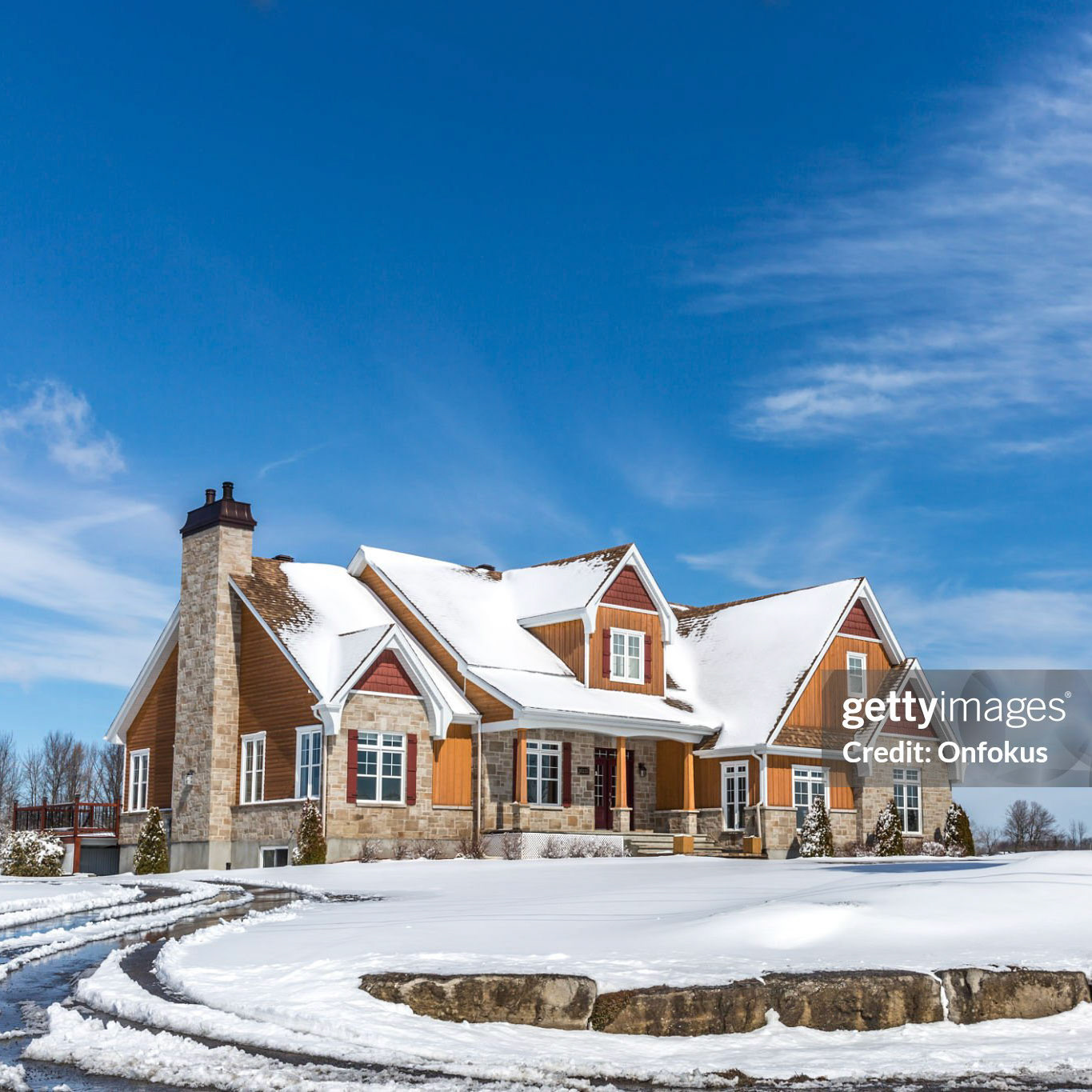 Mirabel, Canada- April 04, 2015: Luxurious wood and stone house located in Mirabel, suburb region of Montreal, during a sunny day of Spring.
