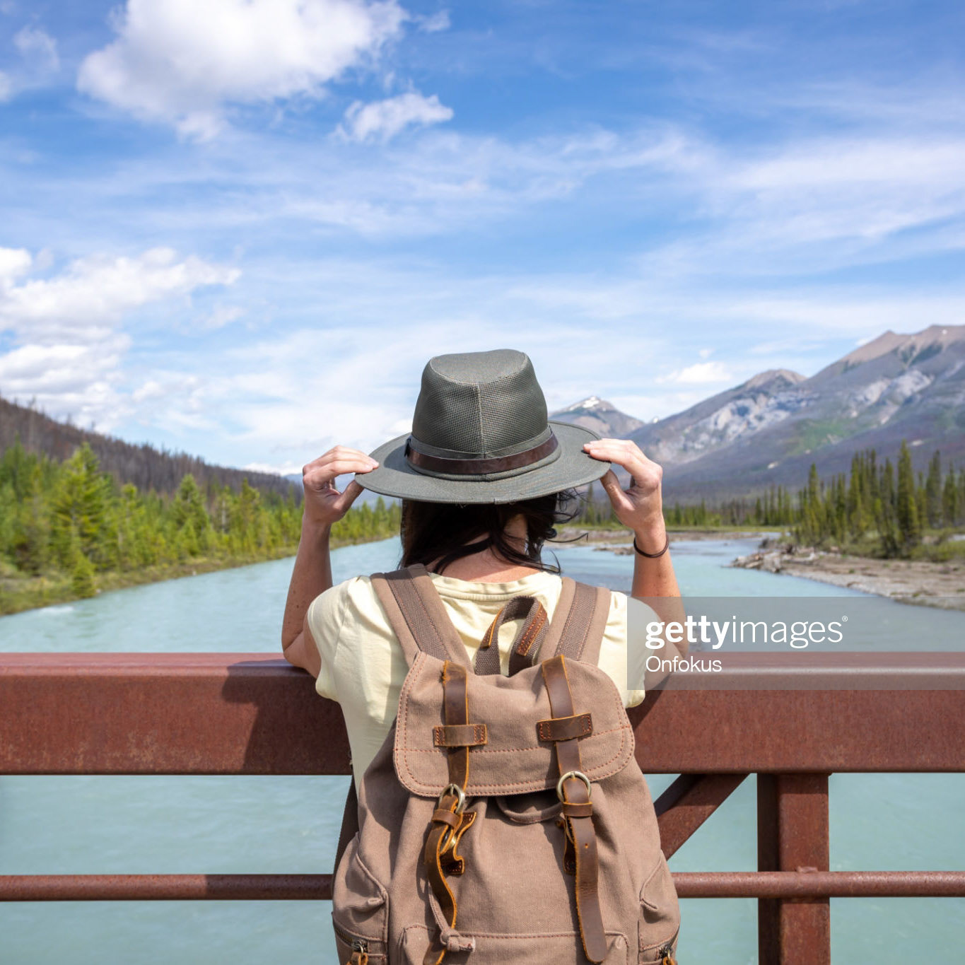 Young Woman Looking at Vermilion River from a bridge in Kootenay National Park, British Columbia, Canada