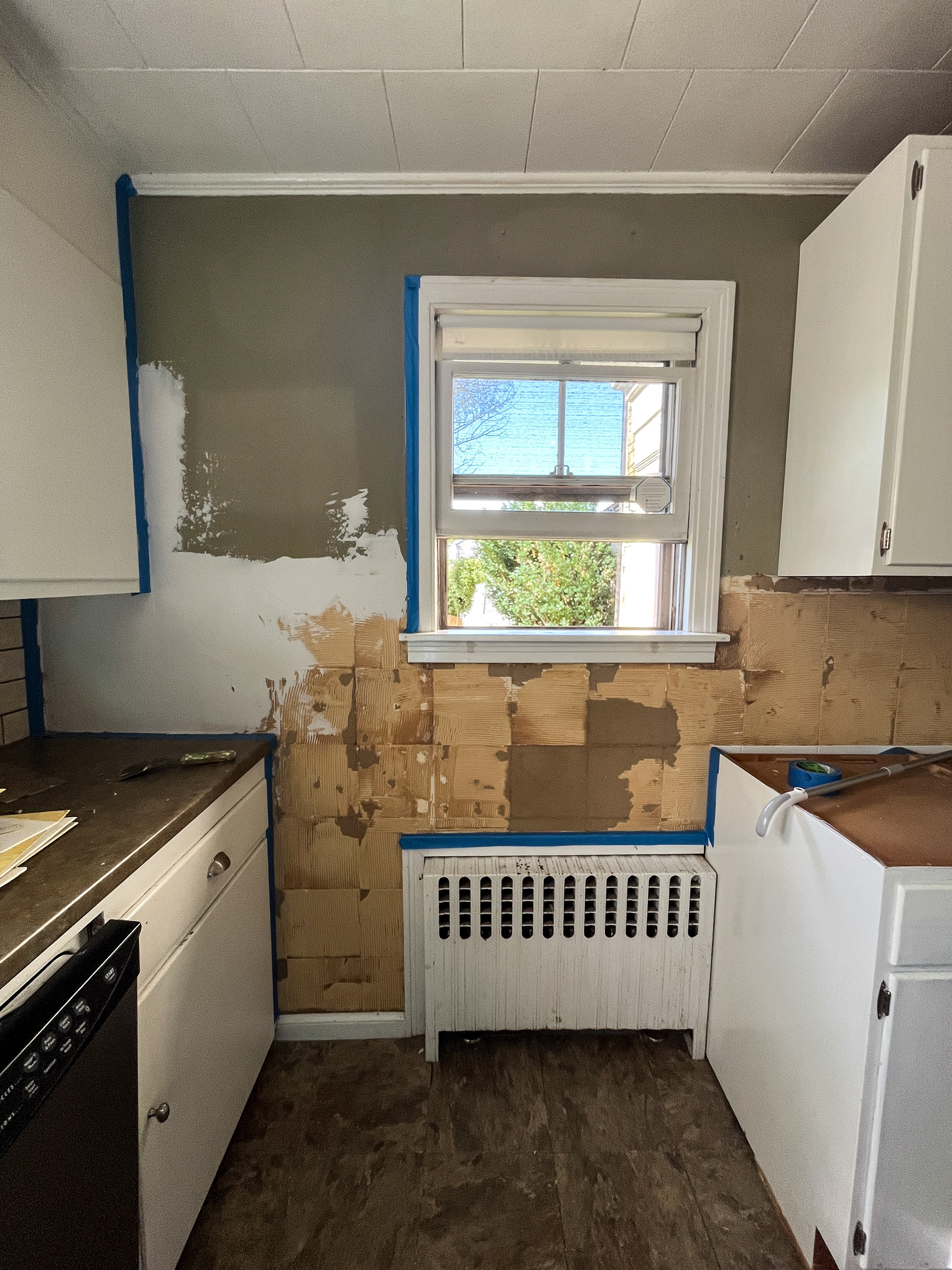 Removing tiles from walls and applying first coat of Joint Compound.
