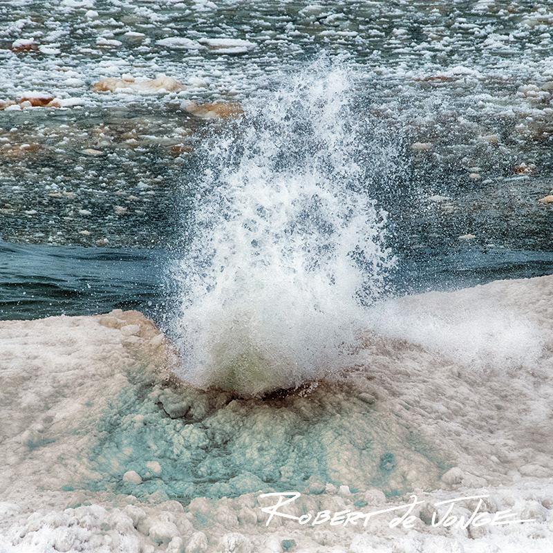 Slush crashes into the ice ridge on the shores of Lake Michigan sending up a teardrop shaped plume