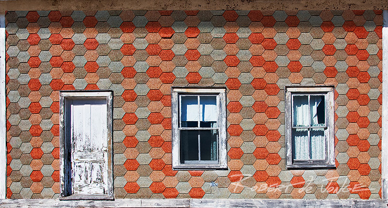 The asphalt single siding on an old farmhouse in Port Oneidaside of a farm