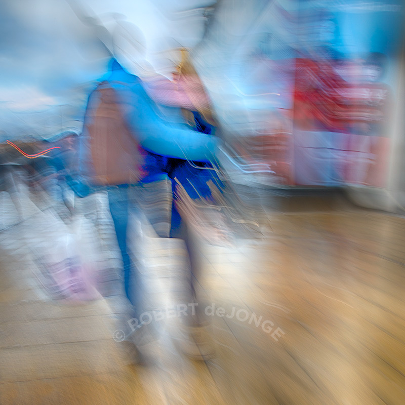 a young couple walk arm in arm along Princes Street