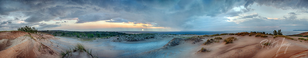 A panorama of Sleeping Bear point at Sunset as a storm passes through