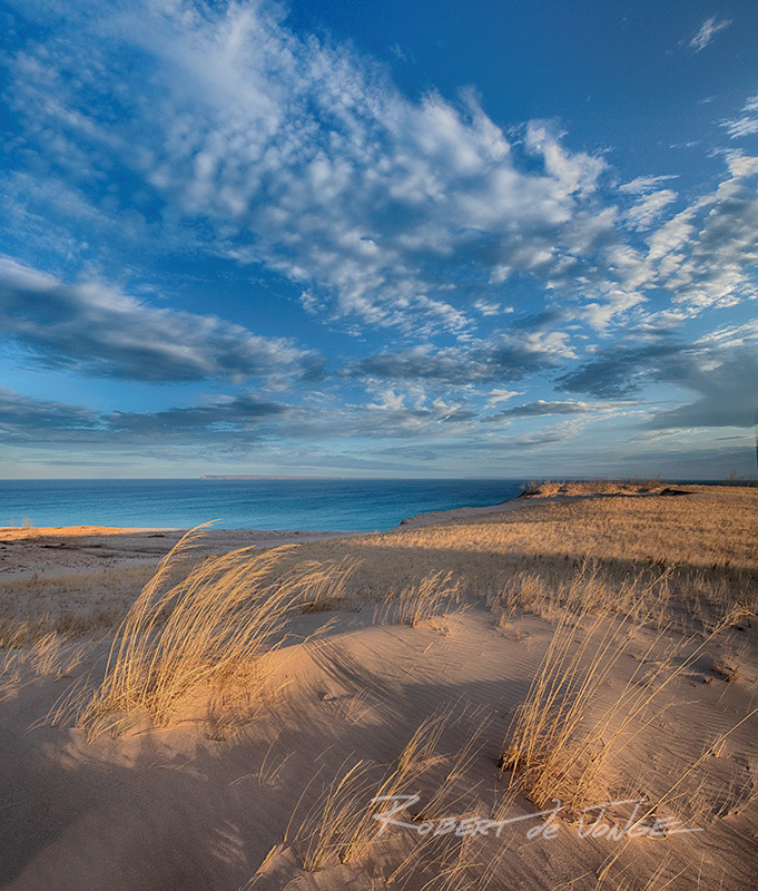 At Sleeping Bear Point the constant wind bends the tall grass on an Autumn morning